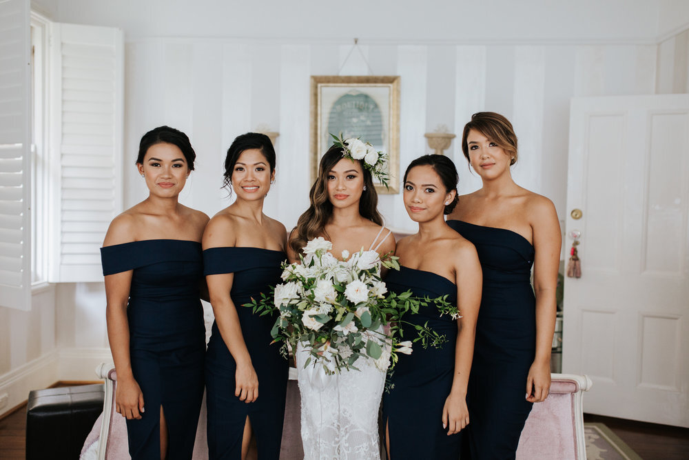 bridesmaids in navy dresses with bride