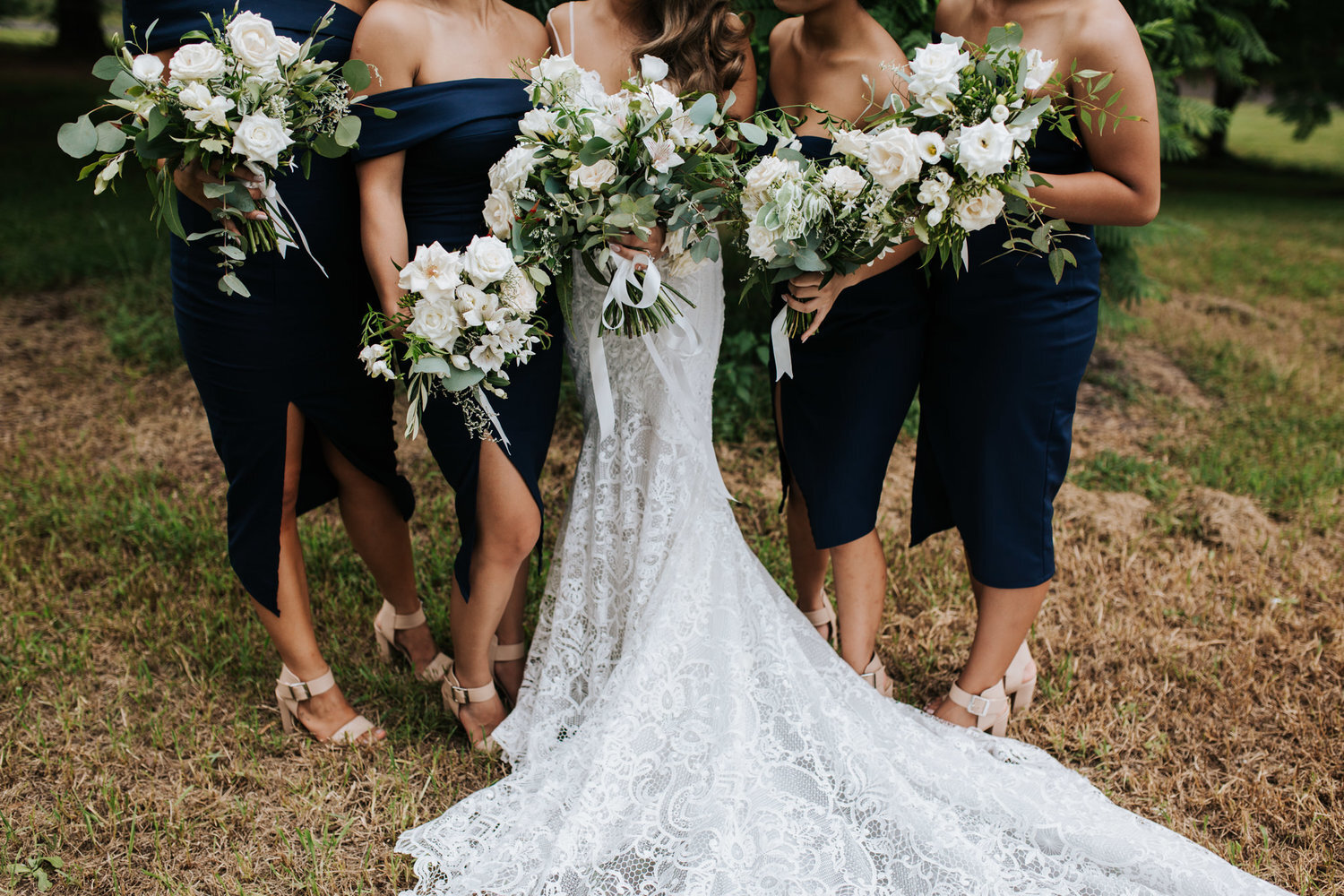 bridesmaids and bridal gown with bouquets