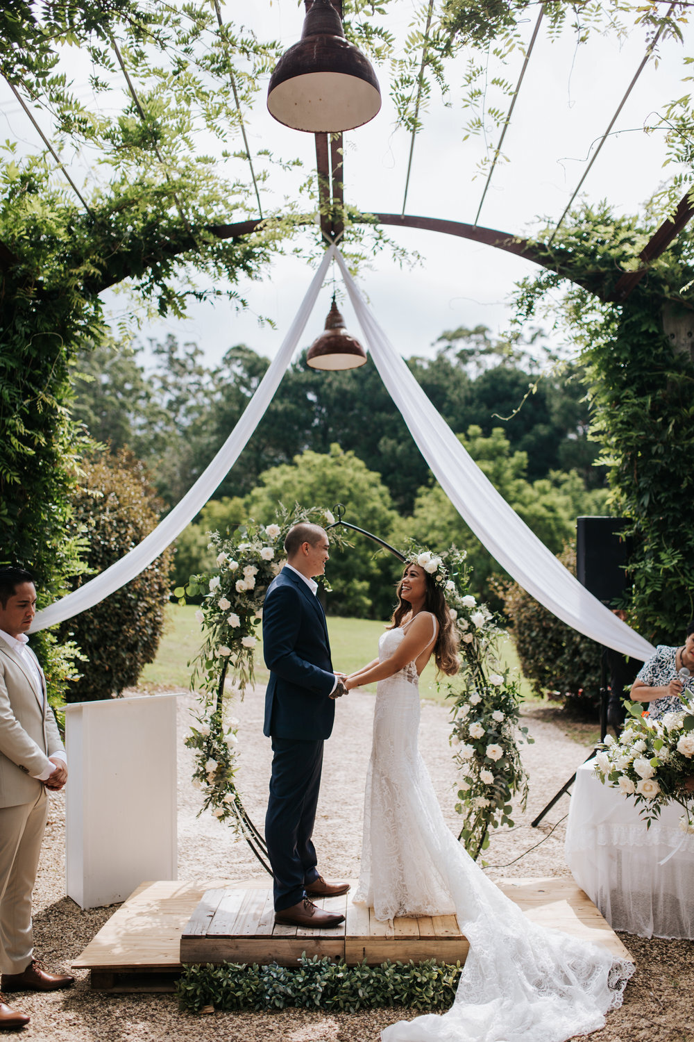 outdoor wedding ceremony with floral arch