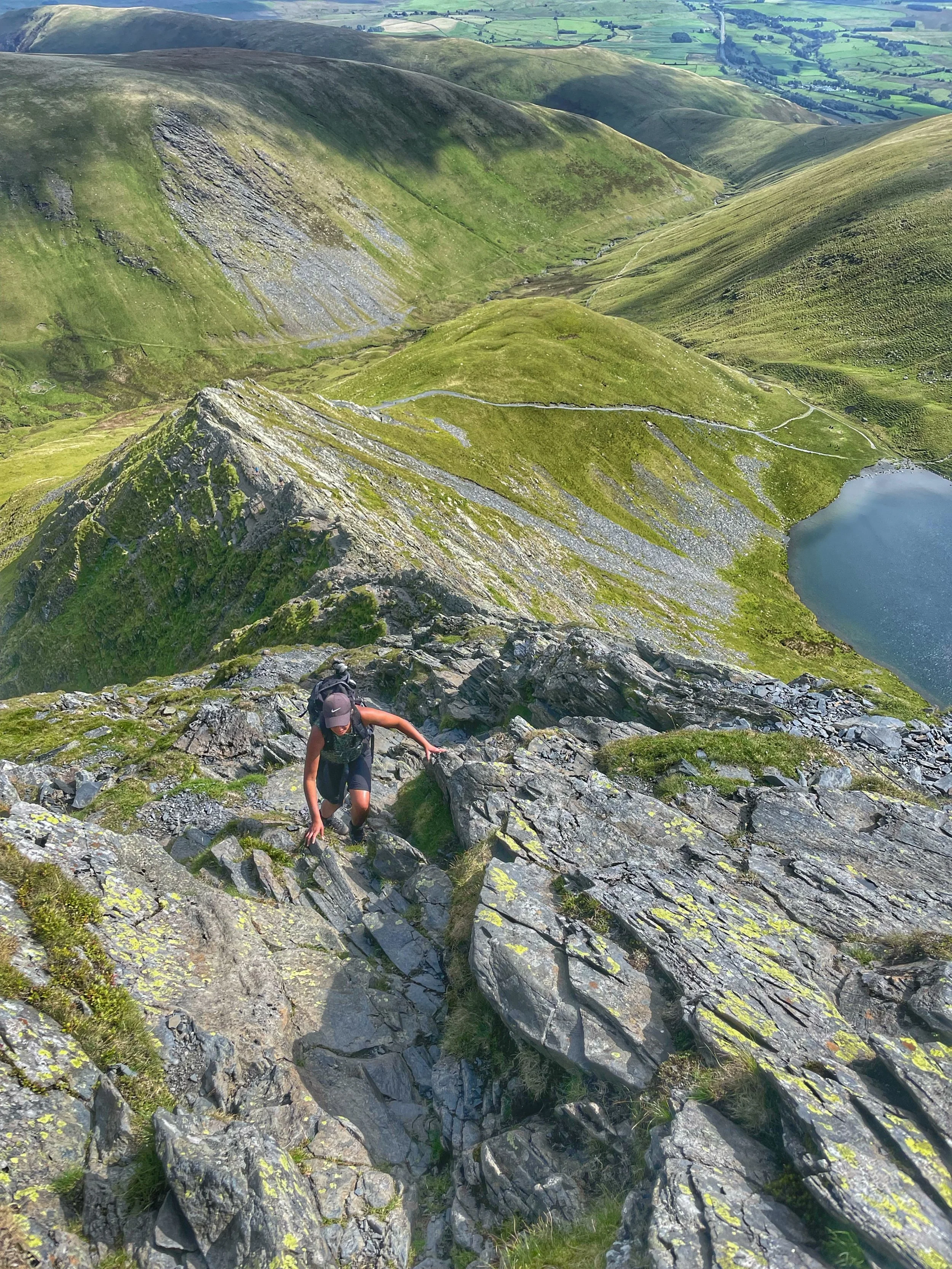 climber traversing the ridge of sharp edge, blencathra guided scrambling with yonder adventure company