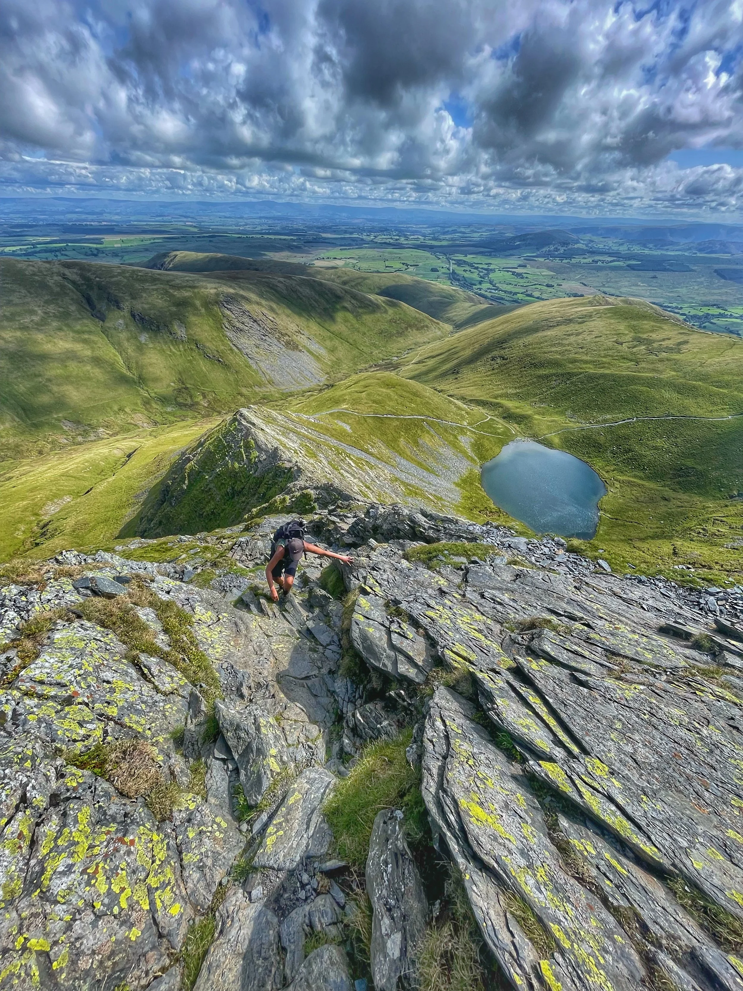 climber traversing the ridge of sharp edge, blencathra guided scrambling with yonder adventure company