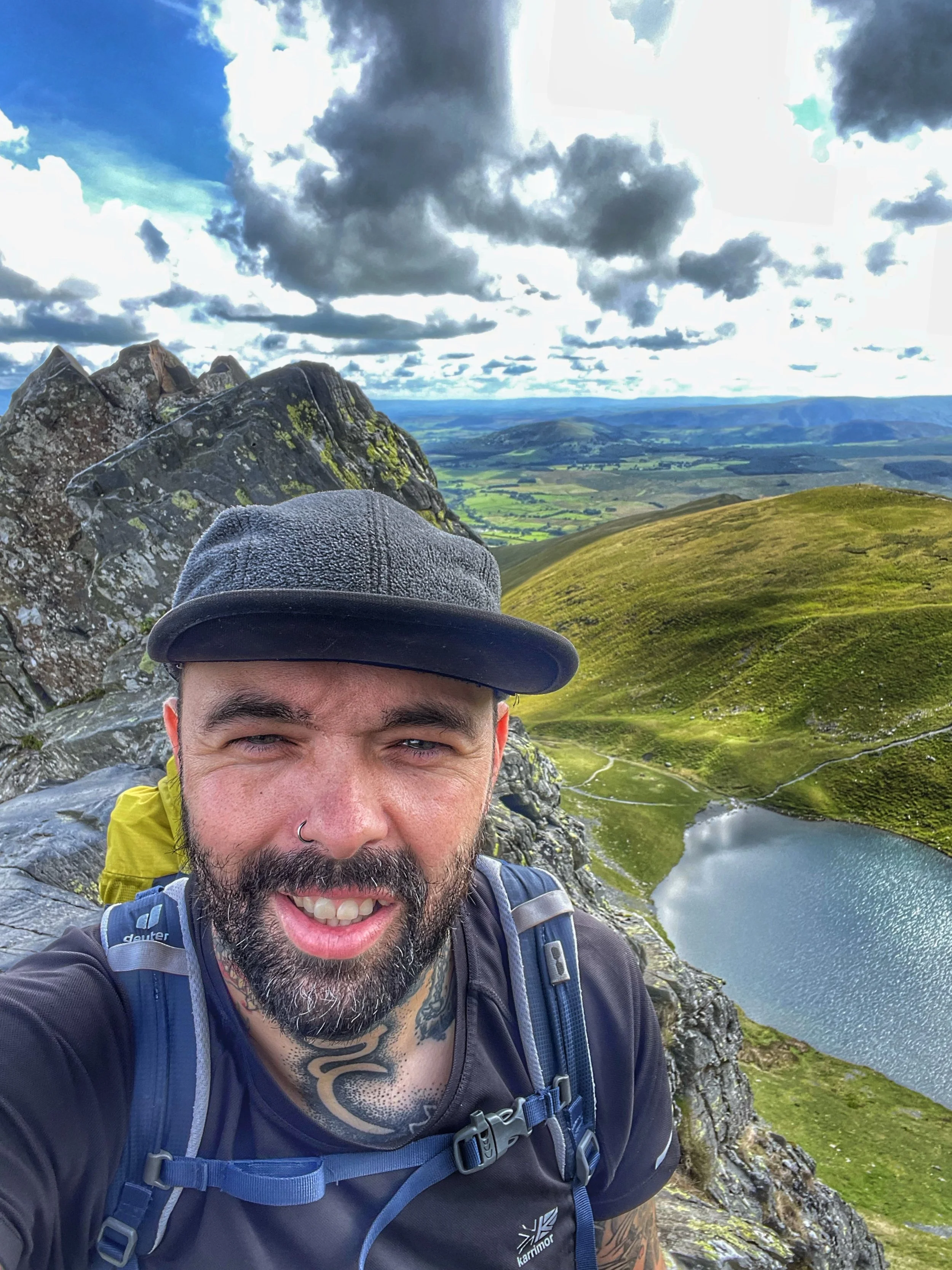 Guided walkers traversing Sharp Edge ridge on Blencathera in the Lake District