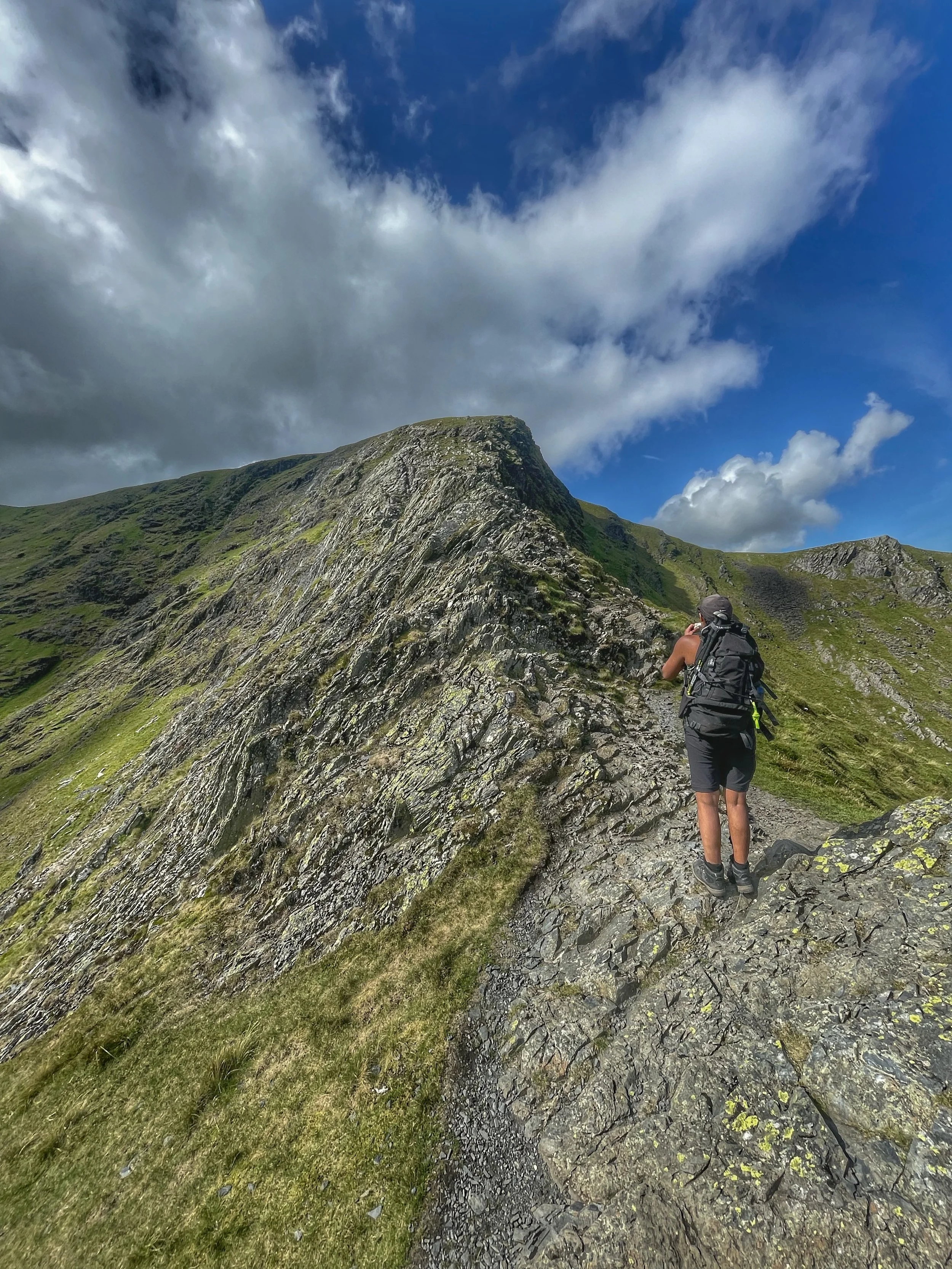 climber traversing the ridge of sharp edge, blencathra guided scrambling with yonder adventure company