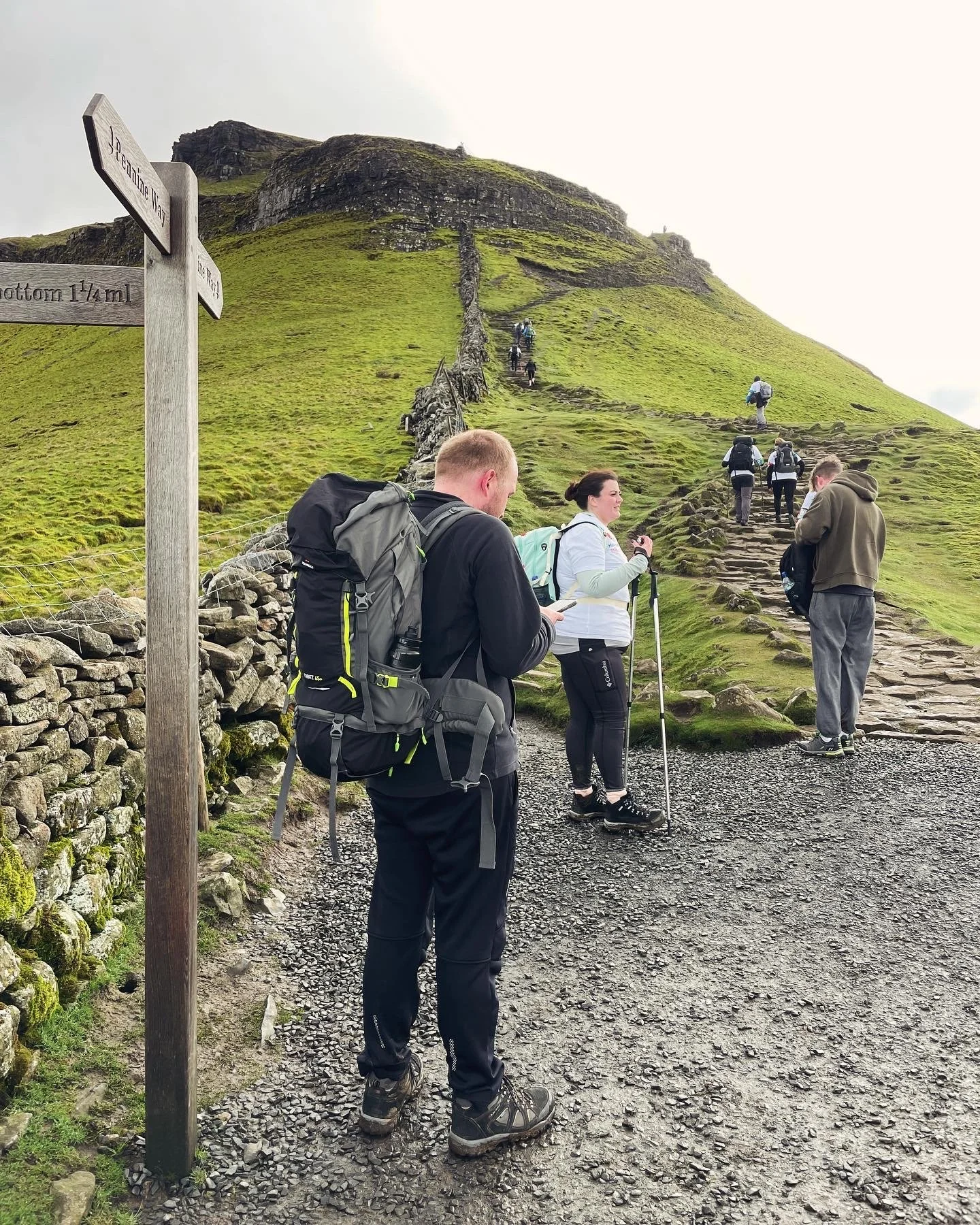 hikers below pen y ghent on the yorkshire three peaks challenge with yonder adventure company