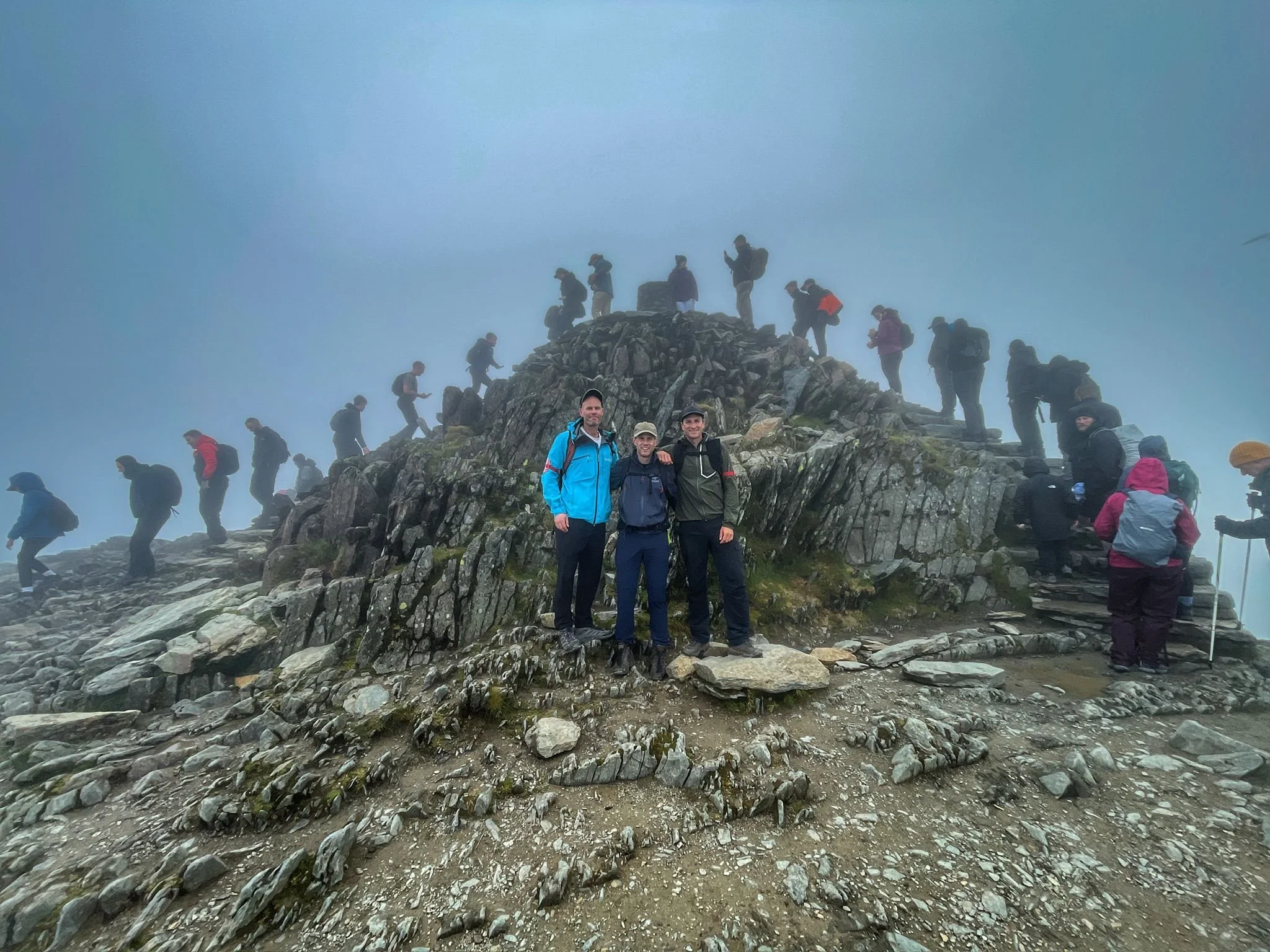 hikers on the summit of yr wyddfa during the snowdon horseshoe