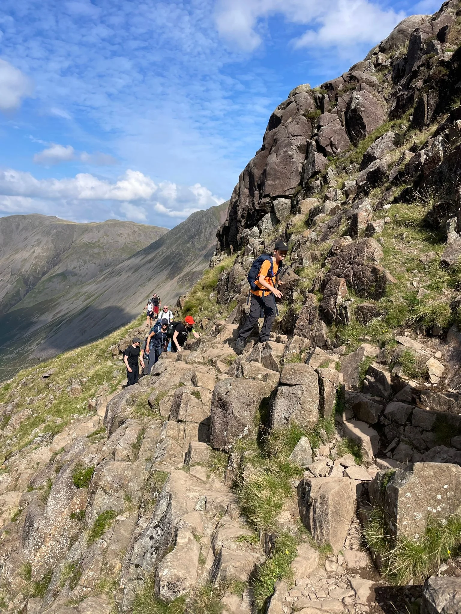 a hiker on the corridor route ascending scafell pike