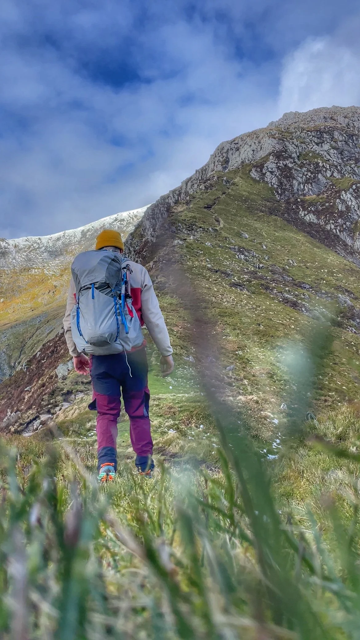 Hiker walking one of the ridge lines on the carneddau mountains on a guided hike with yonder adventure company.