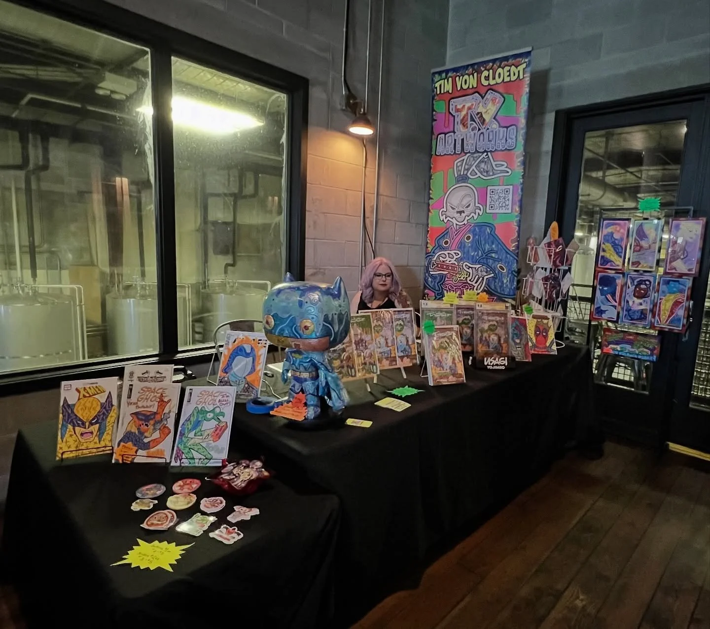 We are set up at @comicsandbrews today. Here&rsquo;s a picture of @gvoncupcake unwillingly getting stuck in the picture of my table setup.

We&rsquo;re here 11-5 at @coppertailbrewing !