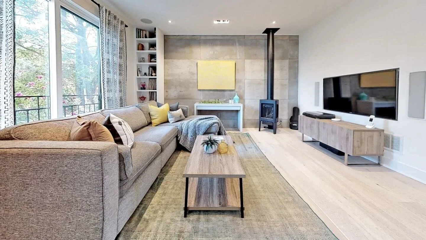 Living room with floor-to-ceiling windows and concrete feature wall at home in The Pocket by Odin Agnuk