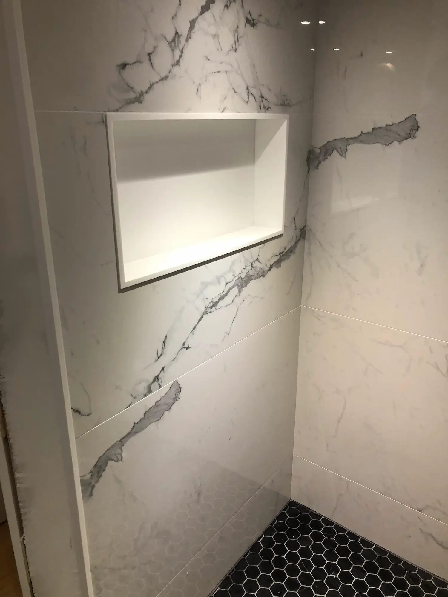 Built-in shower corian alcove with marble tile surround - The Beaches Toronto bathroom renovation by Odin Agnuk