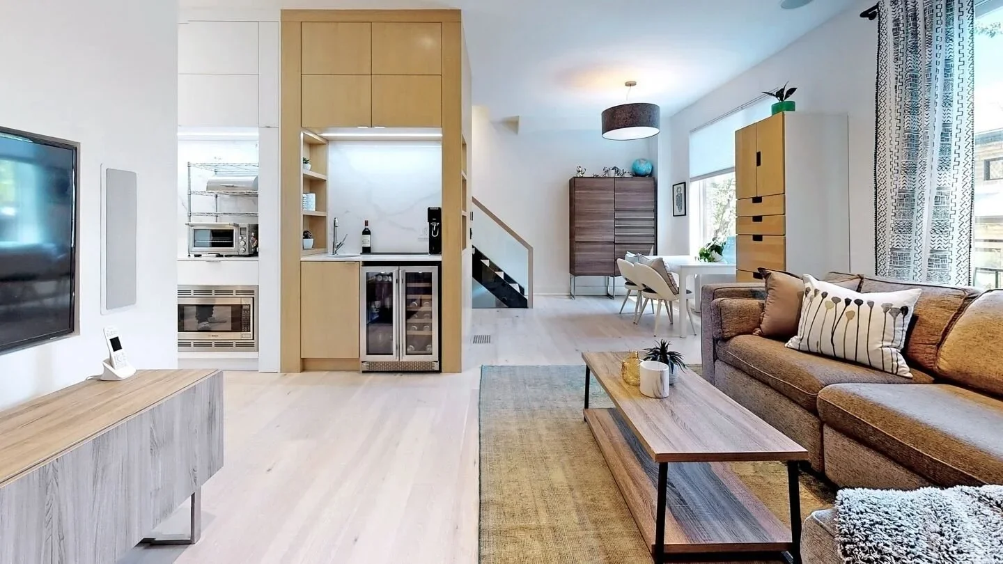 Open concept main floor with wine fridge and custom oak millwork at home in The Pocket Toronto by Odin Agnuk