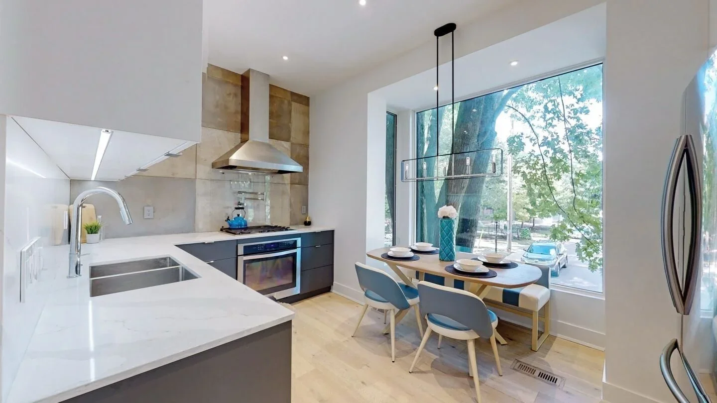 Modern kitchen with quartz countertops and industrial tile backsplash at home in The Pocket, Toronto by Odin Agnuk