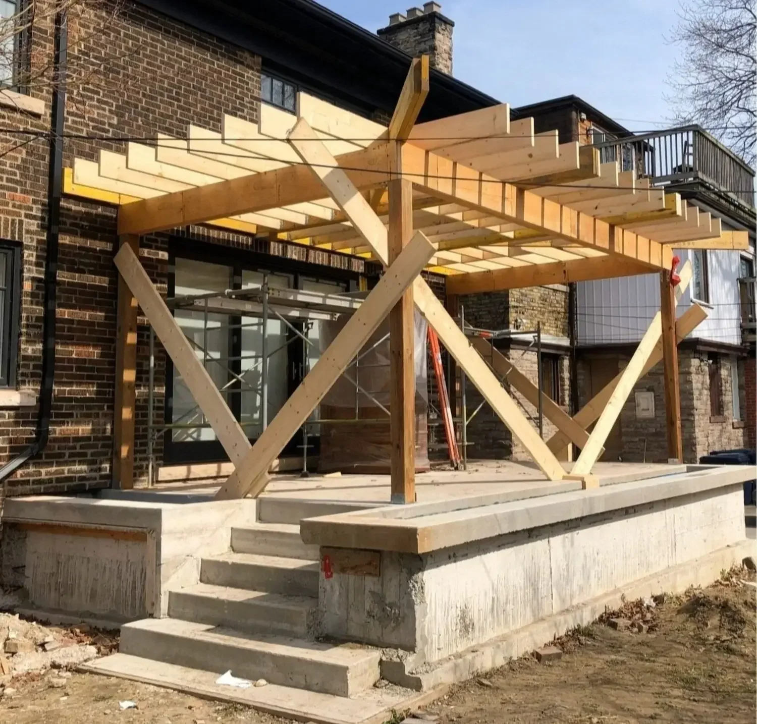 Custom patio pergola timber framing on concrete foundation in Roncesvalles, Toronto by Odin Agnuk