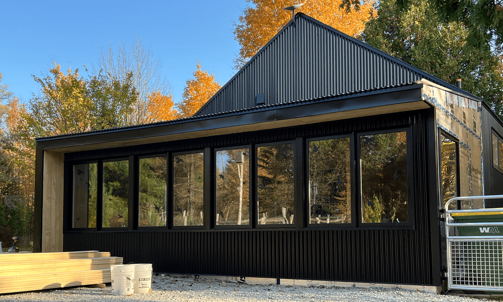 Modern Nordic custom home with corrugated metal and vertical wood siding in Beaver Valley - custom build by Odin Agnuk