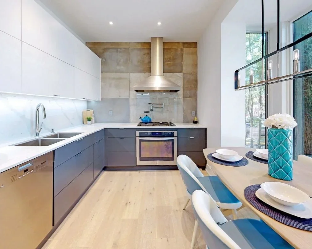 Kitchen renovation with faux concrete wall and carrara backsplash and countertops with Frankie sink in Toronto by Odin Agnuk