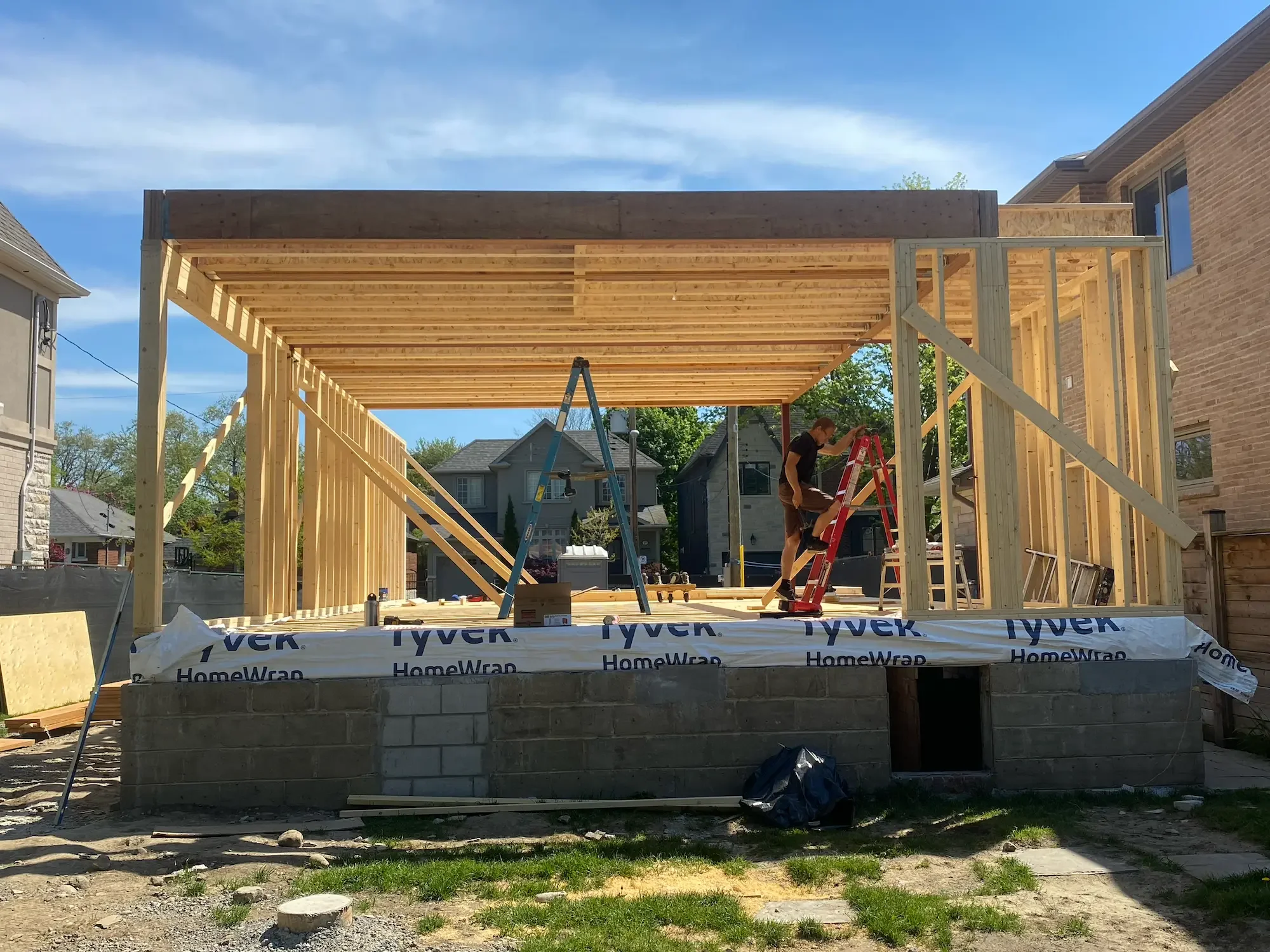 First floor wall and second floor framing with Tyvek house wrap, custom home build in Etobicoke by Odin Agnuk