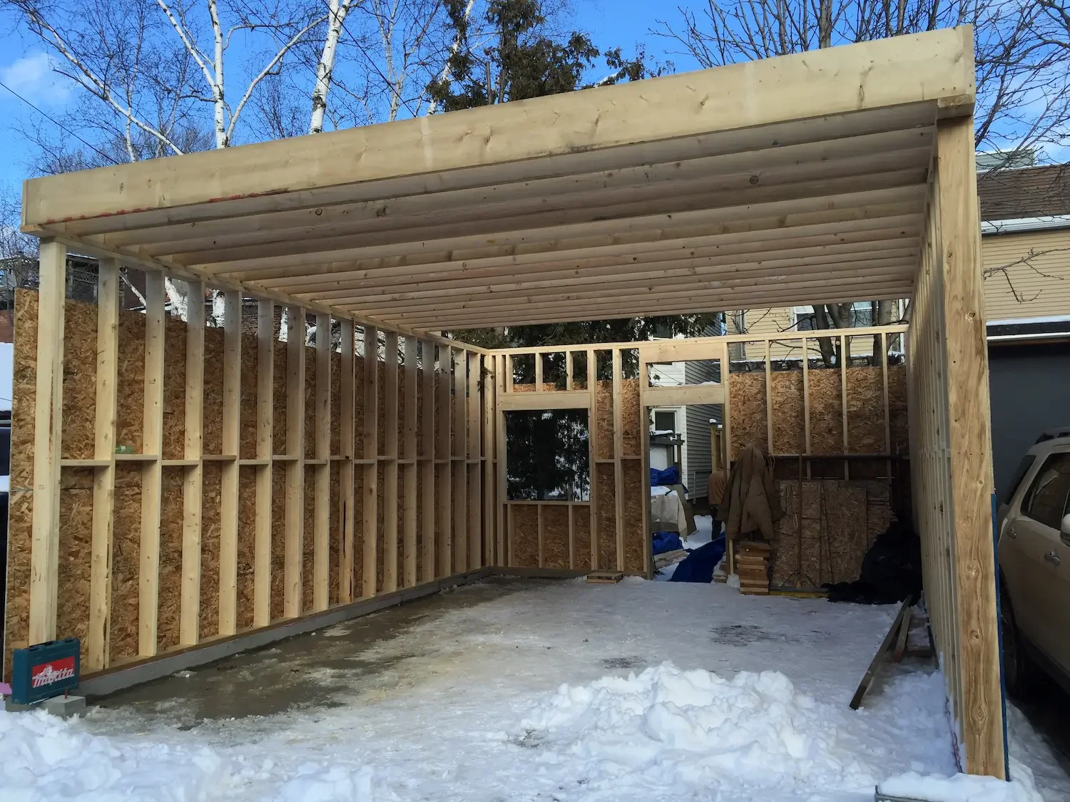 Garage framing with flat roof construction and wall sheathing in Toronto by Odin Agnuk