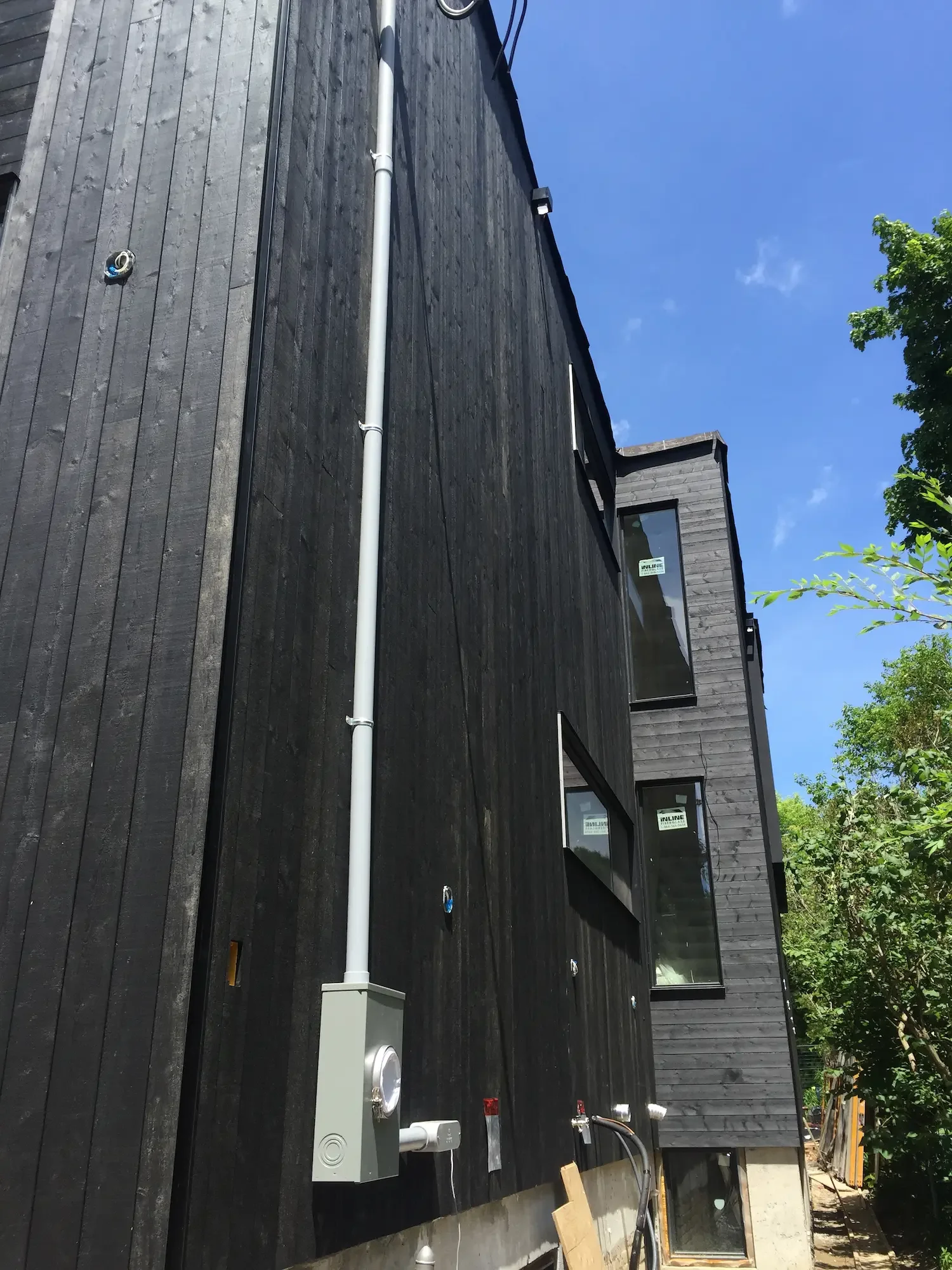 Two-story Maibec black cladding side view - North Riverdale by Odin Agnuk