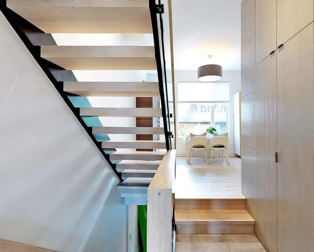 Steel frame staircase with open risers and oak treads at home in The Pocket, Toronto by Odin Agnuk