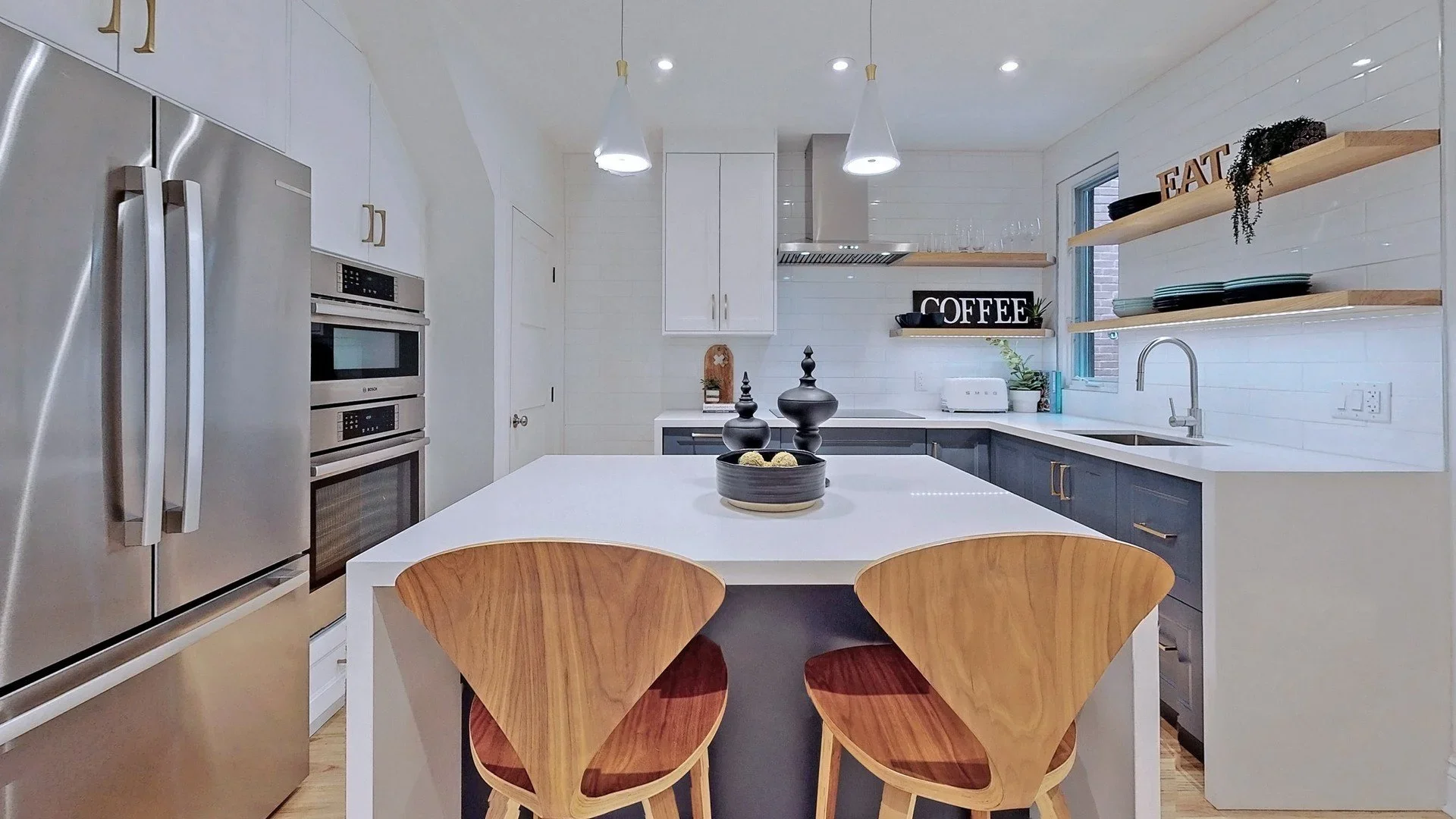 Kitchen renovation with island seating and pendant lights in Leslieville Toronto by Odin Agnuk