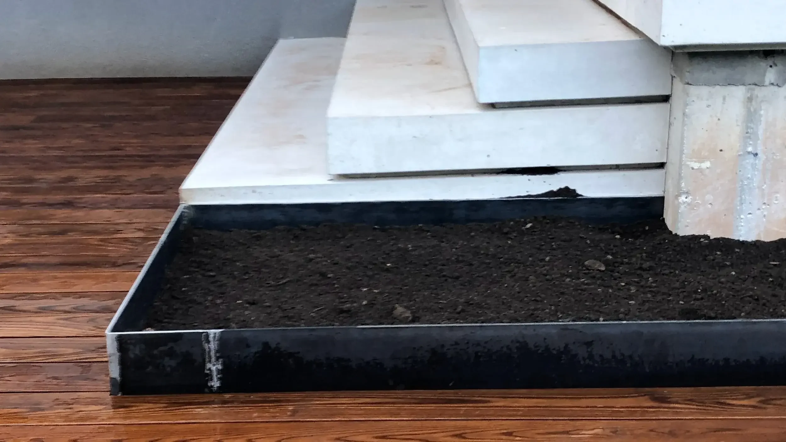 Thermory ash decking with steel planter edge detail in Brant Hills Burlington by Odin Agnuk