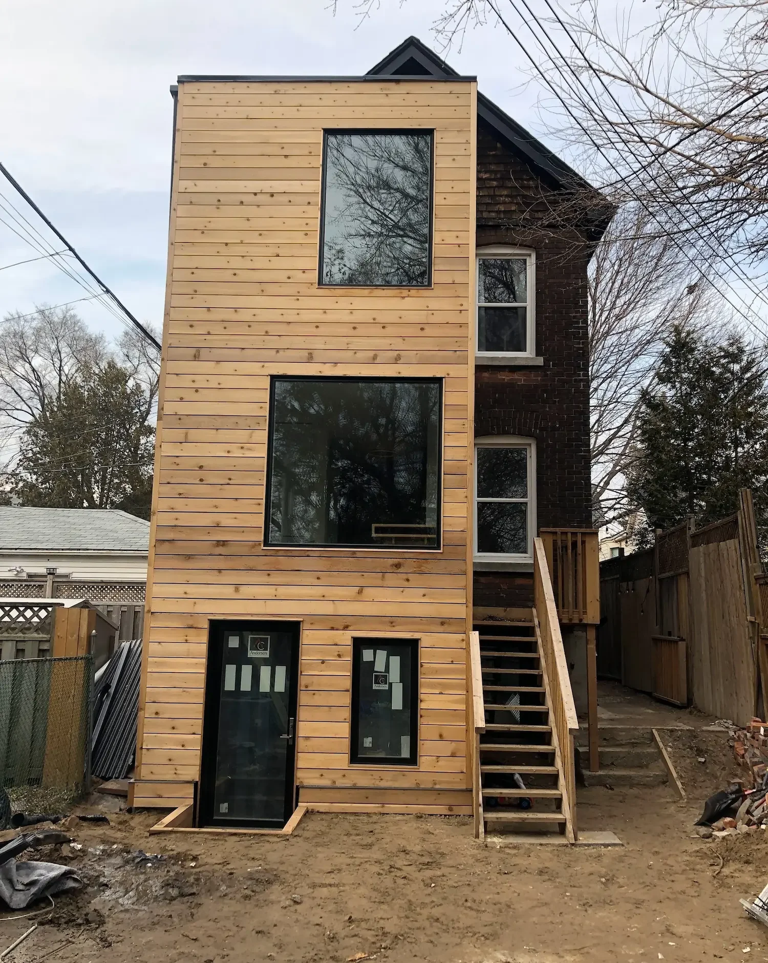 Completed three-story addition with cedar siding - The Beaches Toronto by Odin Agnuk