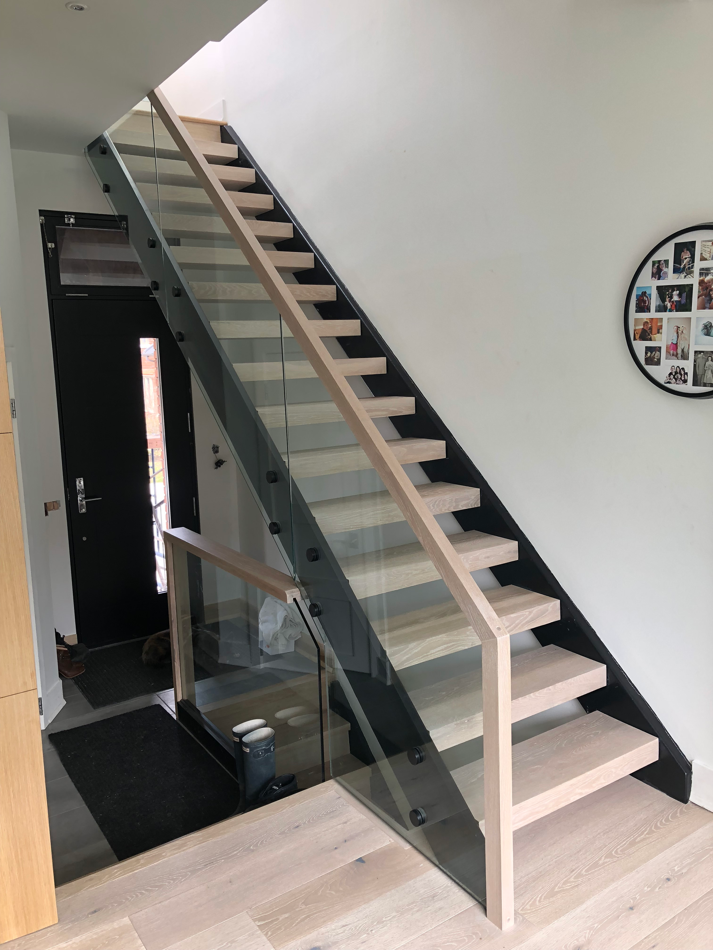 Steel frame staircase with glass railing and oak treads at home in The Pocket Toronto by Odin Agnuk