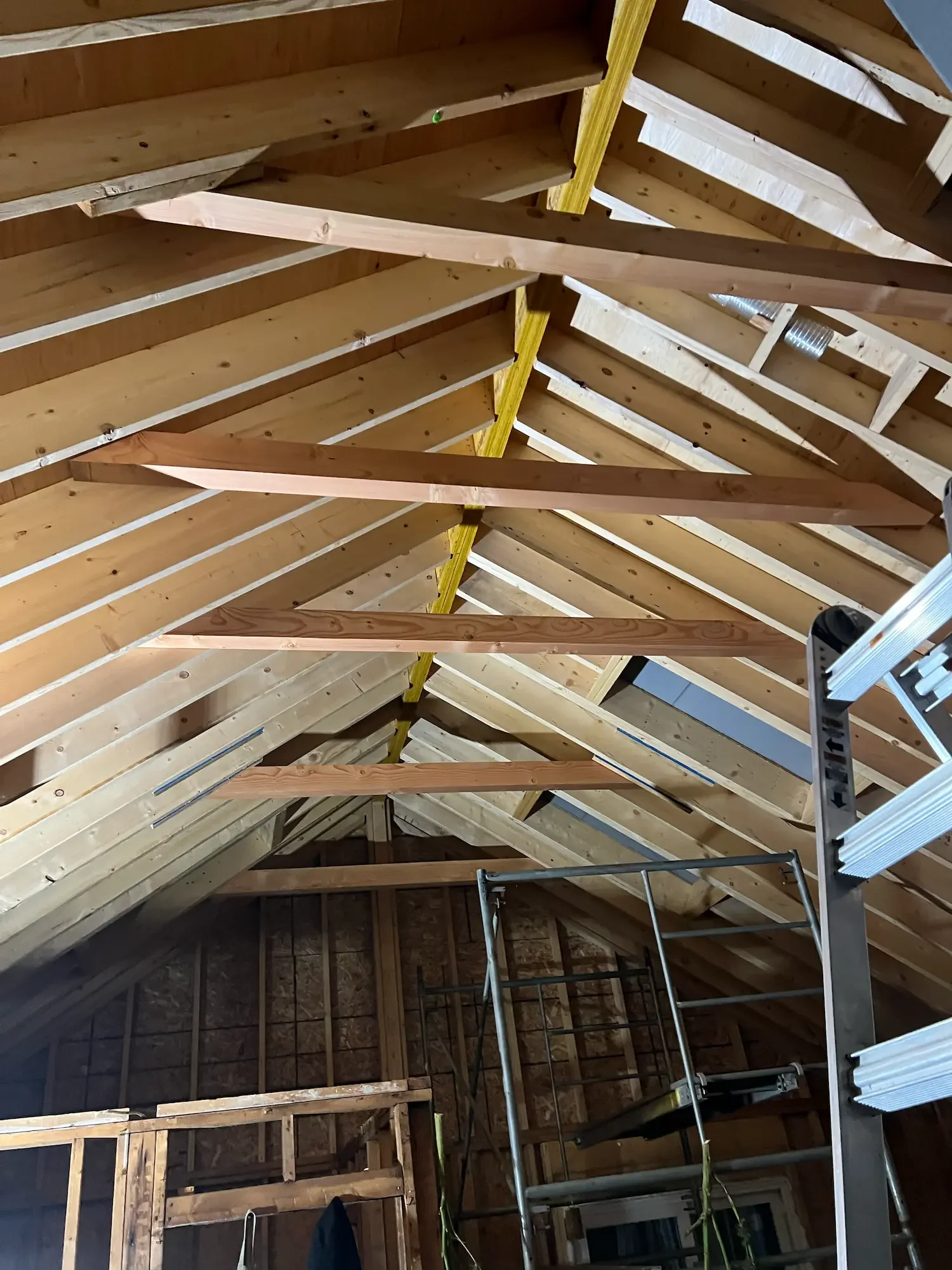 Vaulted ceiling roof framing with exposed rafters and collar ties at Beaver Valley custom home by Odin Agnuk