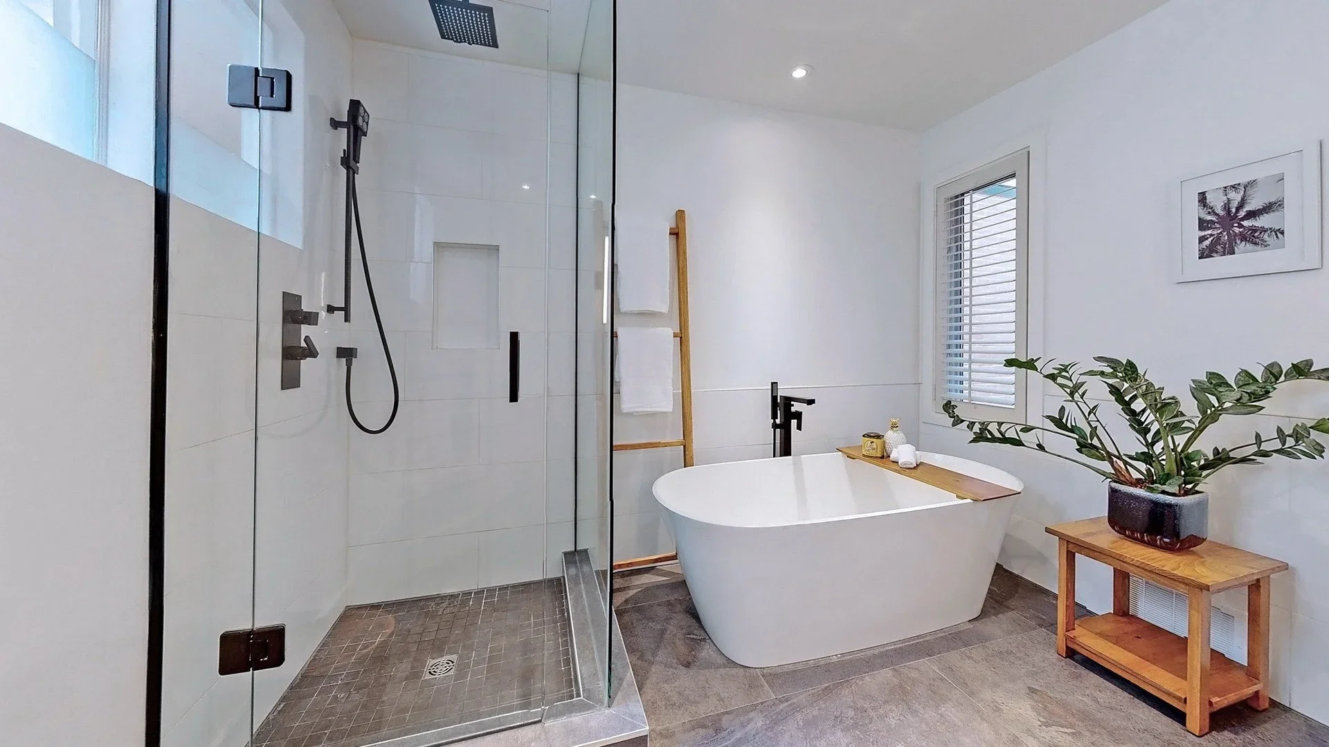 Bathroom renovation with glass shower enclosure and freestanding tub in Leslieville Toronto by Odin Agnuk