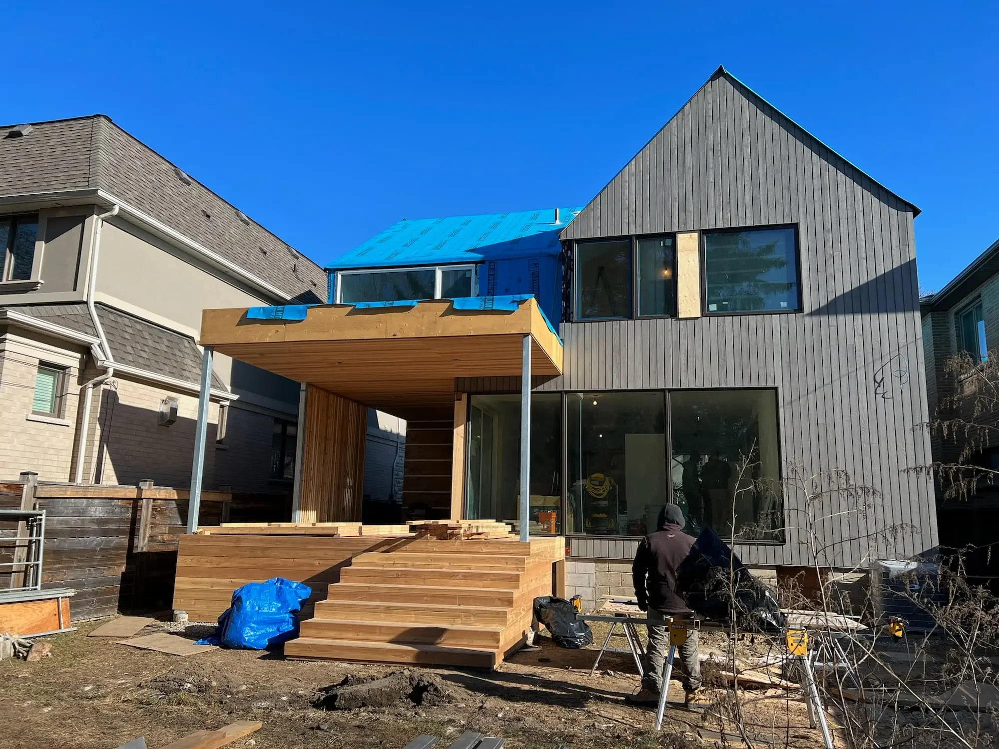 Modern custom home with Maibec vertical siding, cedar deck, and architectural privacy screen in Etobicoke by Odin Agnuk