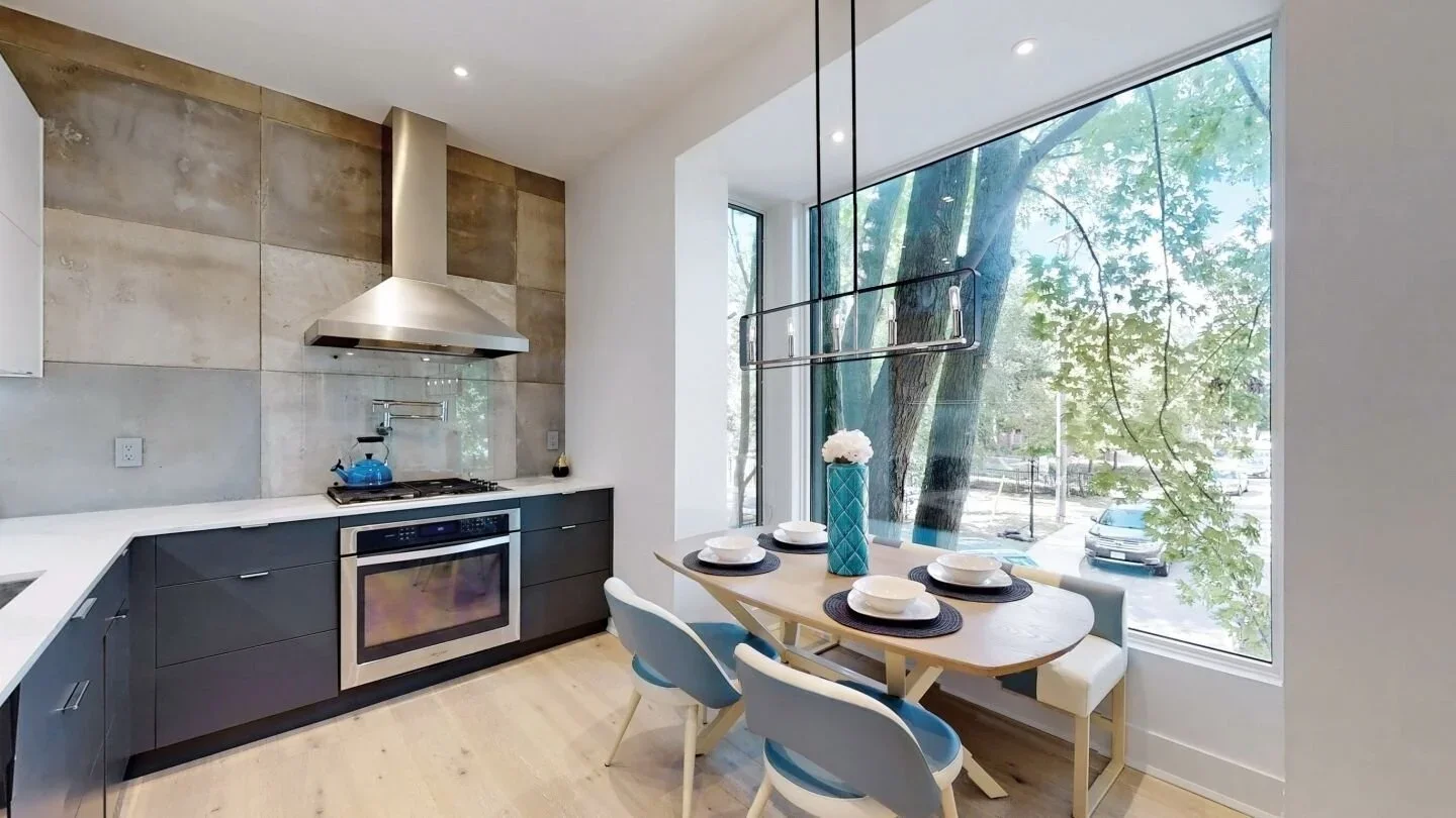 Kitchen with large format tile backsplash and floor-to-ceiling picture window in The Pocket, Toronto by Odin Agnuk