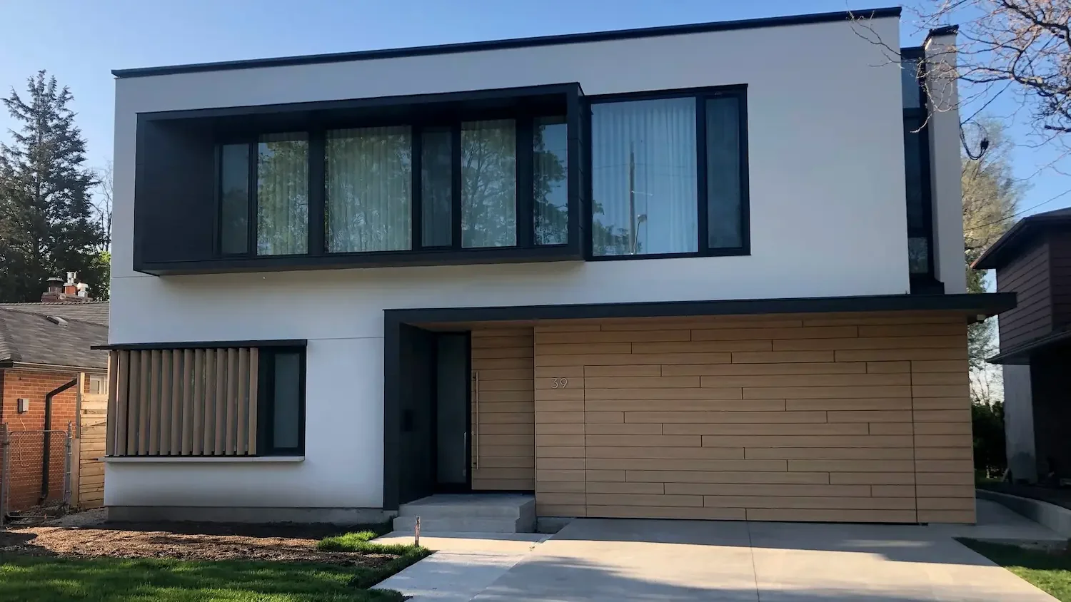 Completed modern home with Trespa Pura NFC cladding and louvered privacy screen at Scarborough Bluffs by Odin Agnuk
