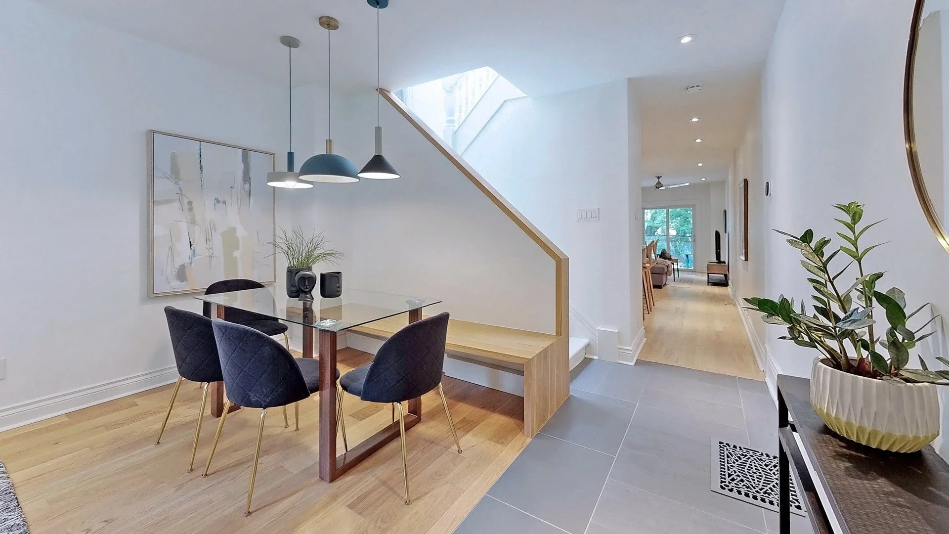 Dining room with custom oak bench and integrated staircase railing and refinished hardwood floors by Odin Agnuk