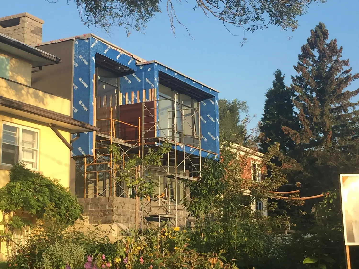 Modern home addition with ipe horizontal siding installation in progress Toronto by Odin Agnuk