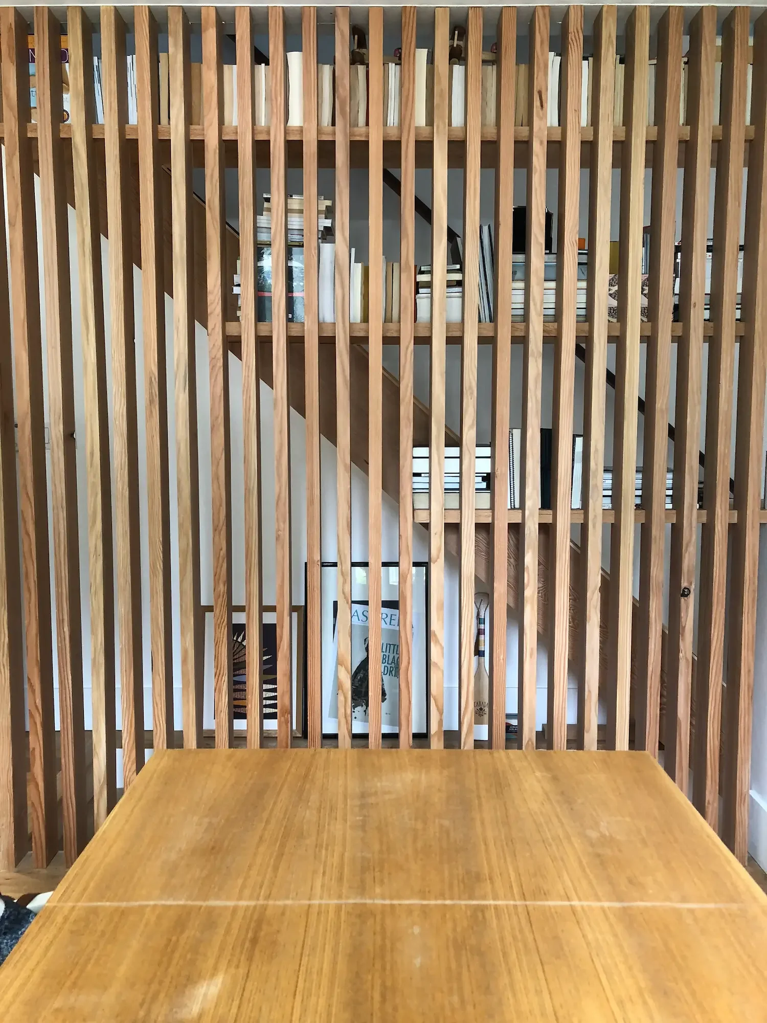 Custom architectural screen room divider with integrated bookshelf - The Beaches Toronto by Odin Agnuk