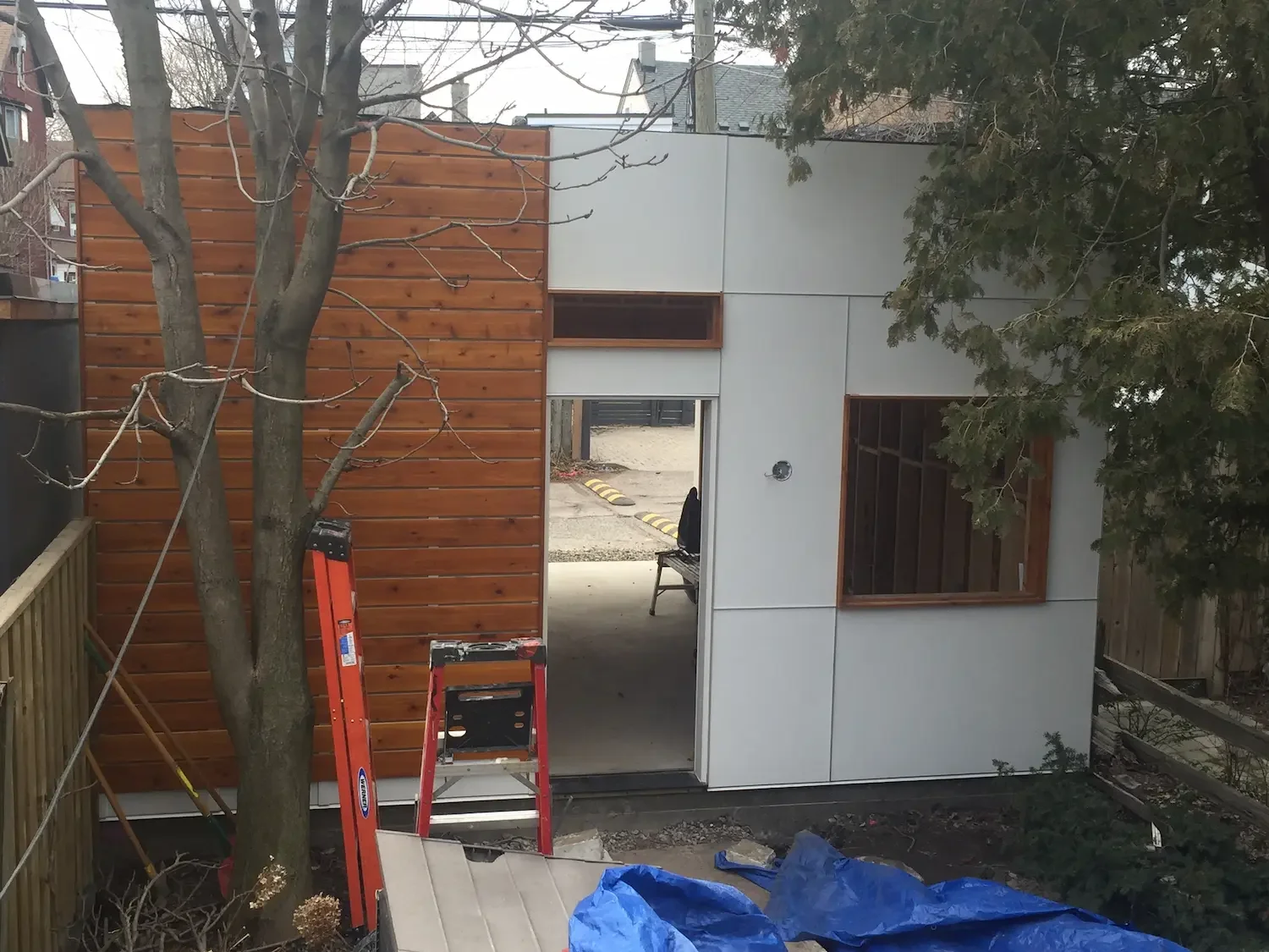 Garage with cedar horizontal siding and panel cladding installation in Toronto by Odin Agnuk