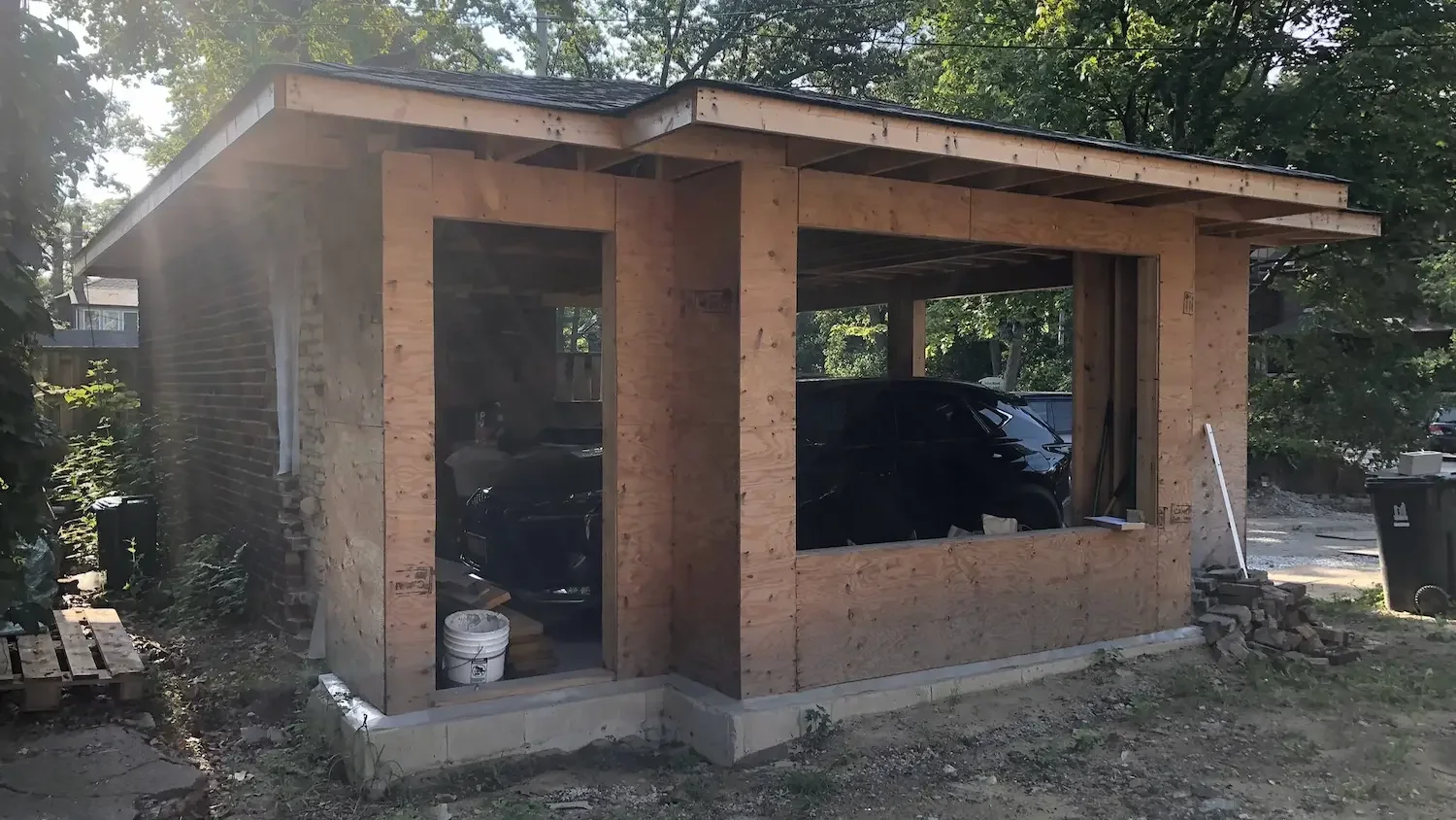 Garage expansion framing and plywood sheathing with roof structure in Roncesvalles, Toronto by Odin Agnuk