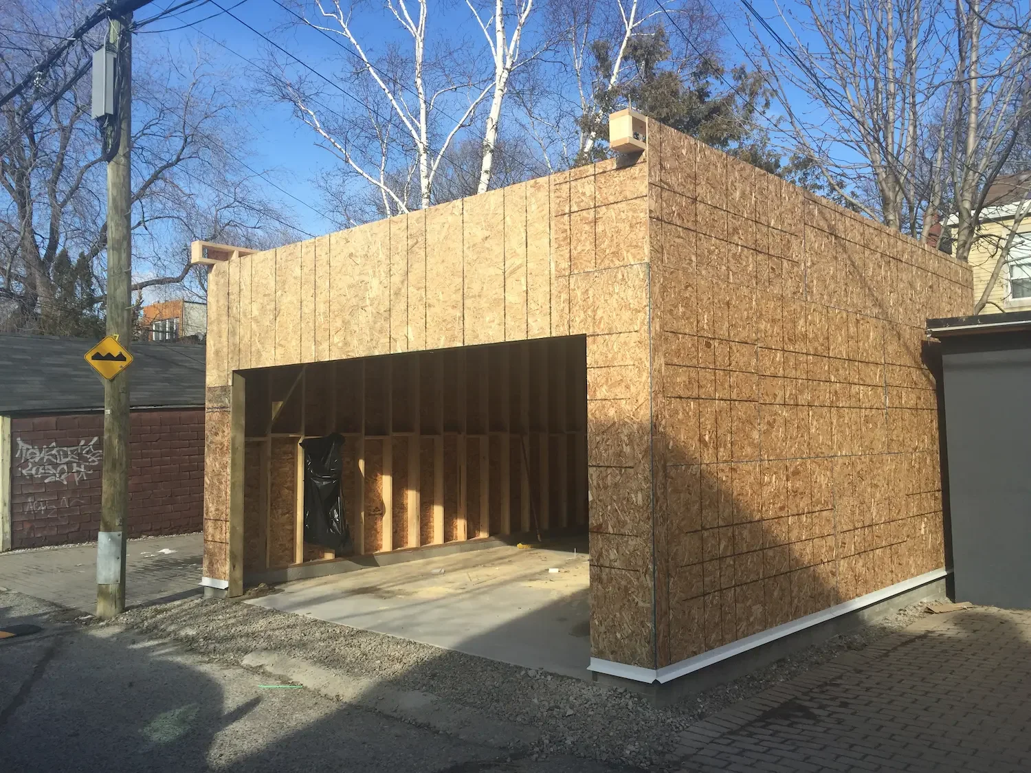 Garage exterior sheathing and flat roof framing completed in Toronto by Odin Agnuk