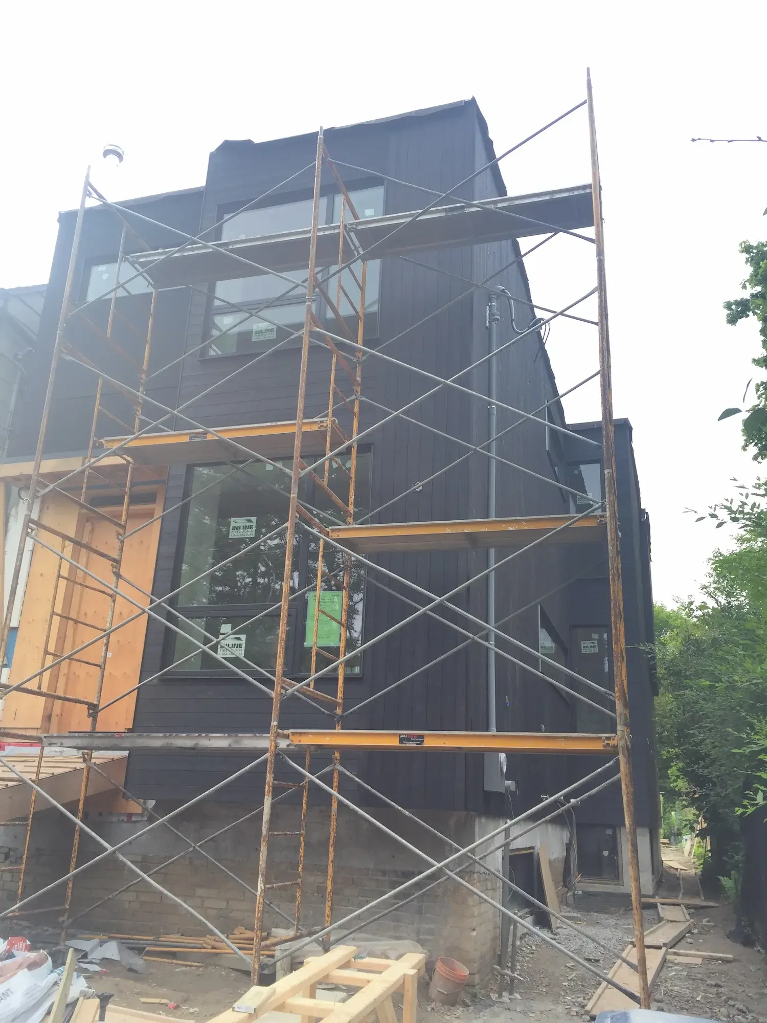 Two-story home with Maibec black horizontal and vertical cladding in installation progress - North Riverdale by Odin Agnuk