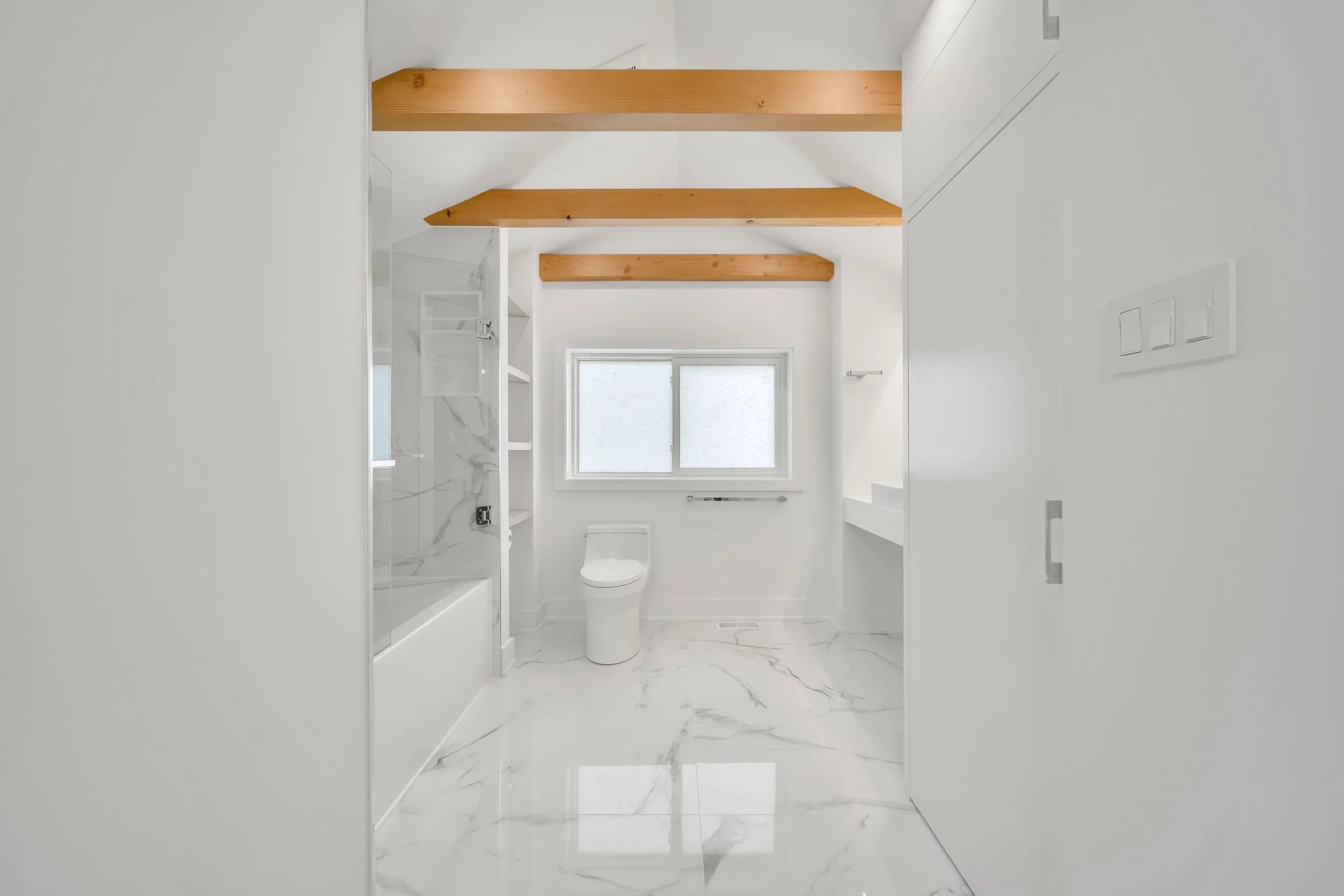 Bathroom renovation with carrara tiles fir exposed beams floating vanity vessel sink in Guelph by Odin Agnuk