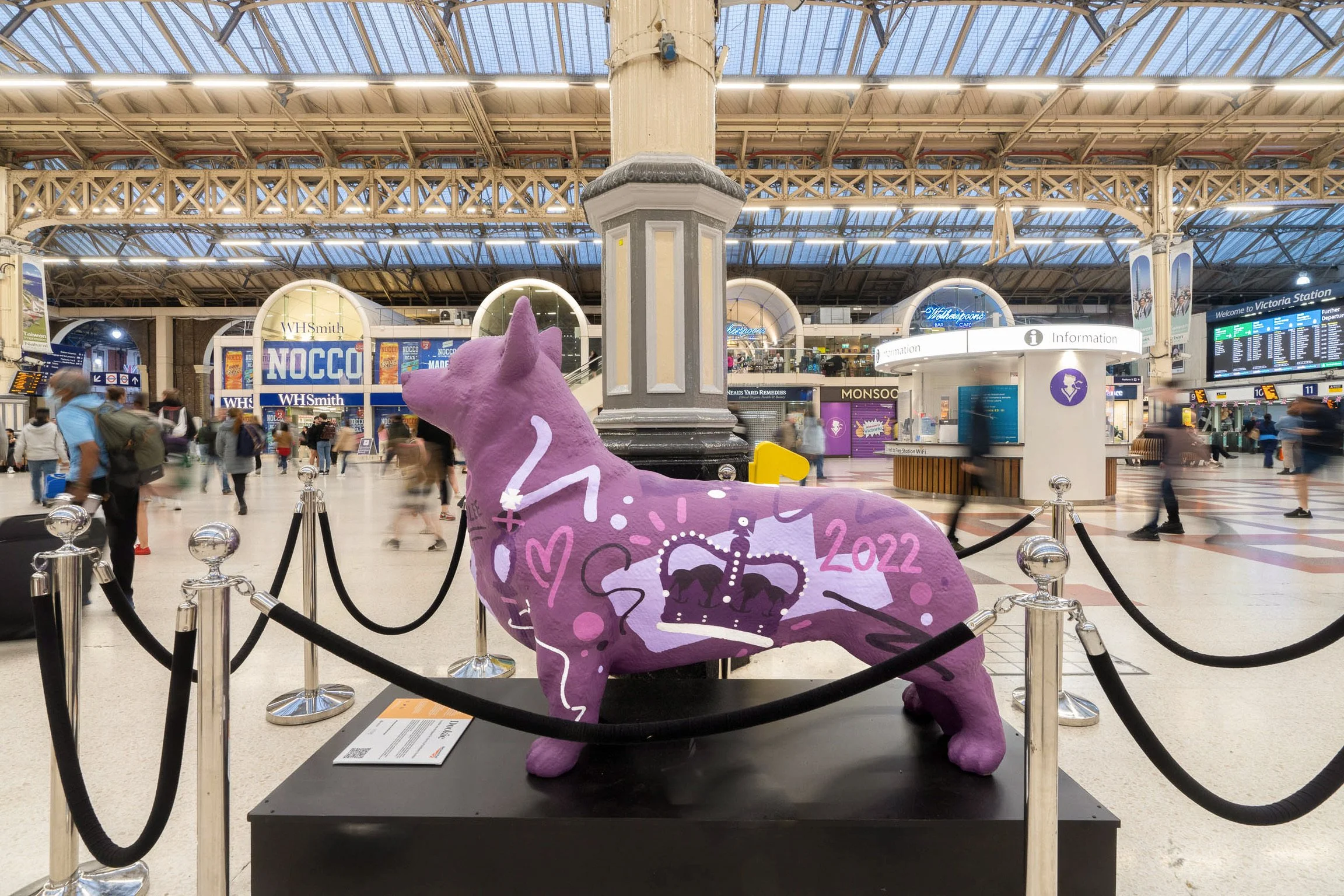 Colourful corgi sculpture painted by K&B Design in a Victoria train station for Queen Elizabeths Platinum Jubilee.