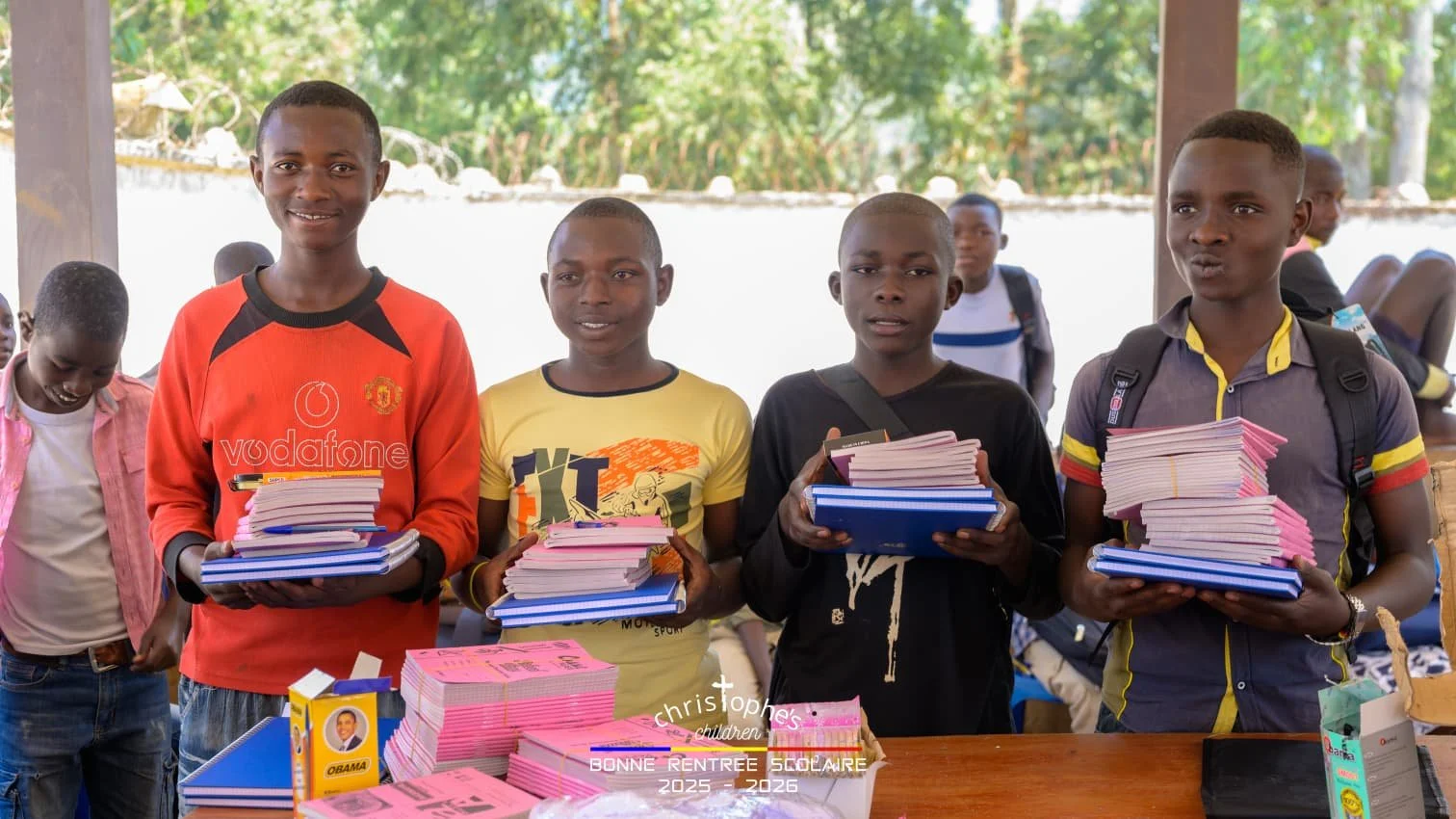 Adolph, Solomon, Innocent and Dieu-Merci picking up their school supplies