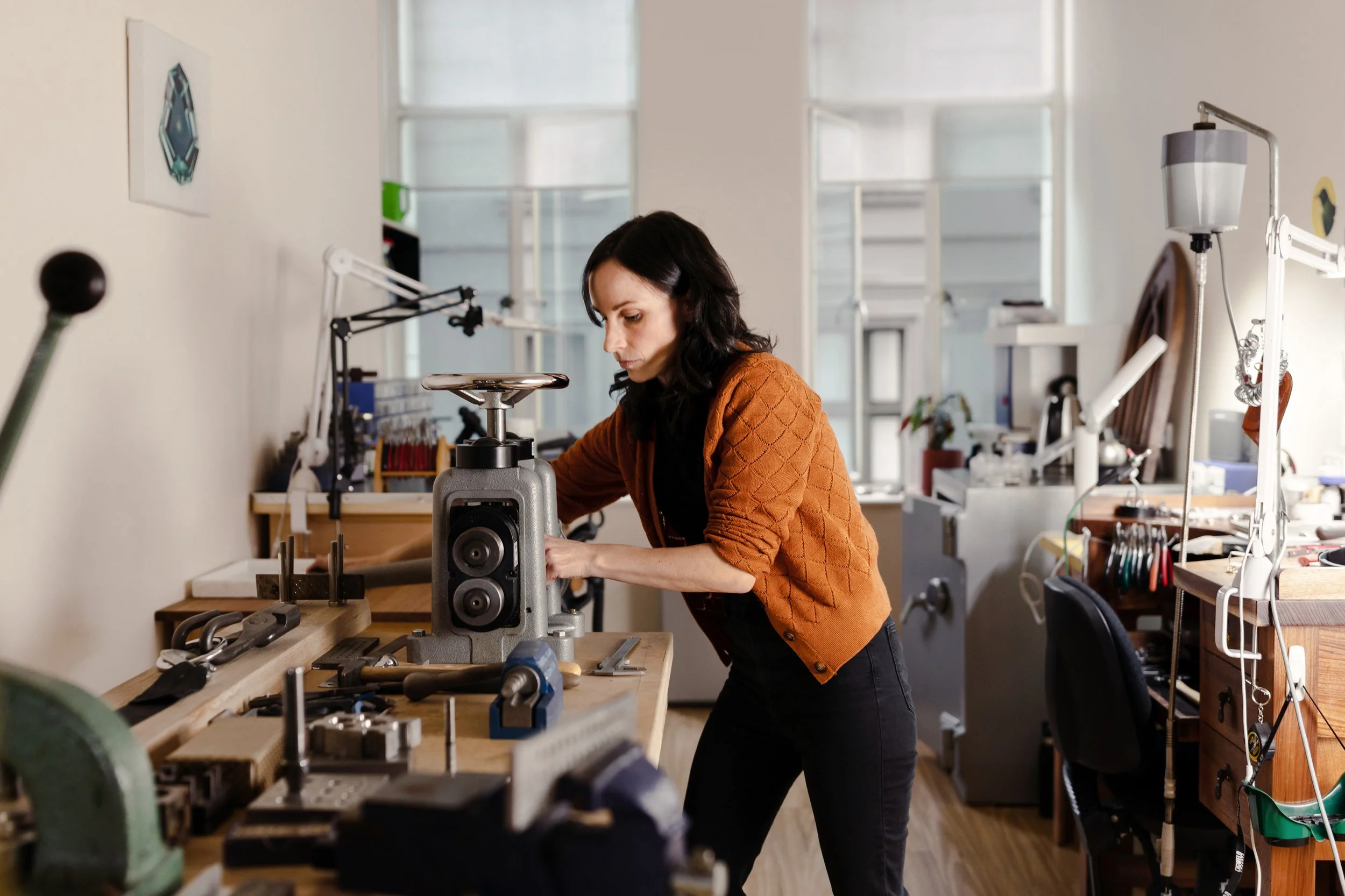 Goldsmith working with tools in a jewellery studio