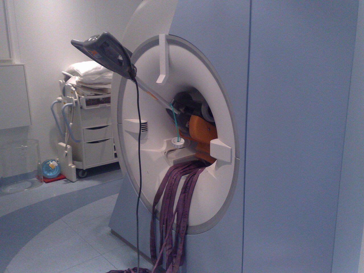 a floor cleaner machine flopping half out of an MRI machine, which has a really, really powerful magnet