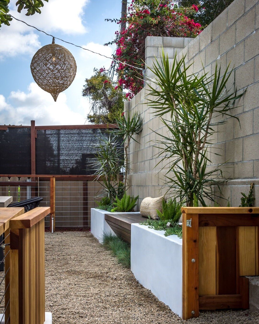 A bench featuring built-in planters and ornamental grass at its base feels like a magical little spot to spend a Friday afternoon.⁣
⁣
📸 : Emma Almendarez⁣
⁣
#southpark_branchout #branchoutwithjenny⁣
⁣
Garden Design &amp; Exterior Decor: @branchoutla