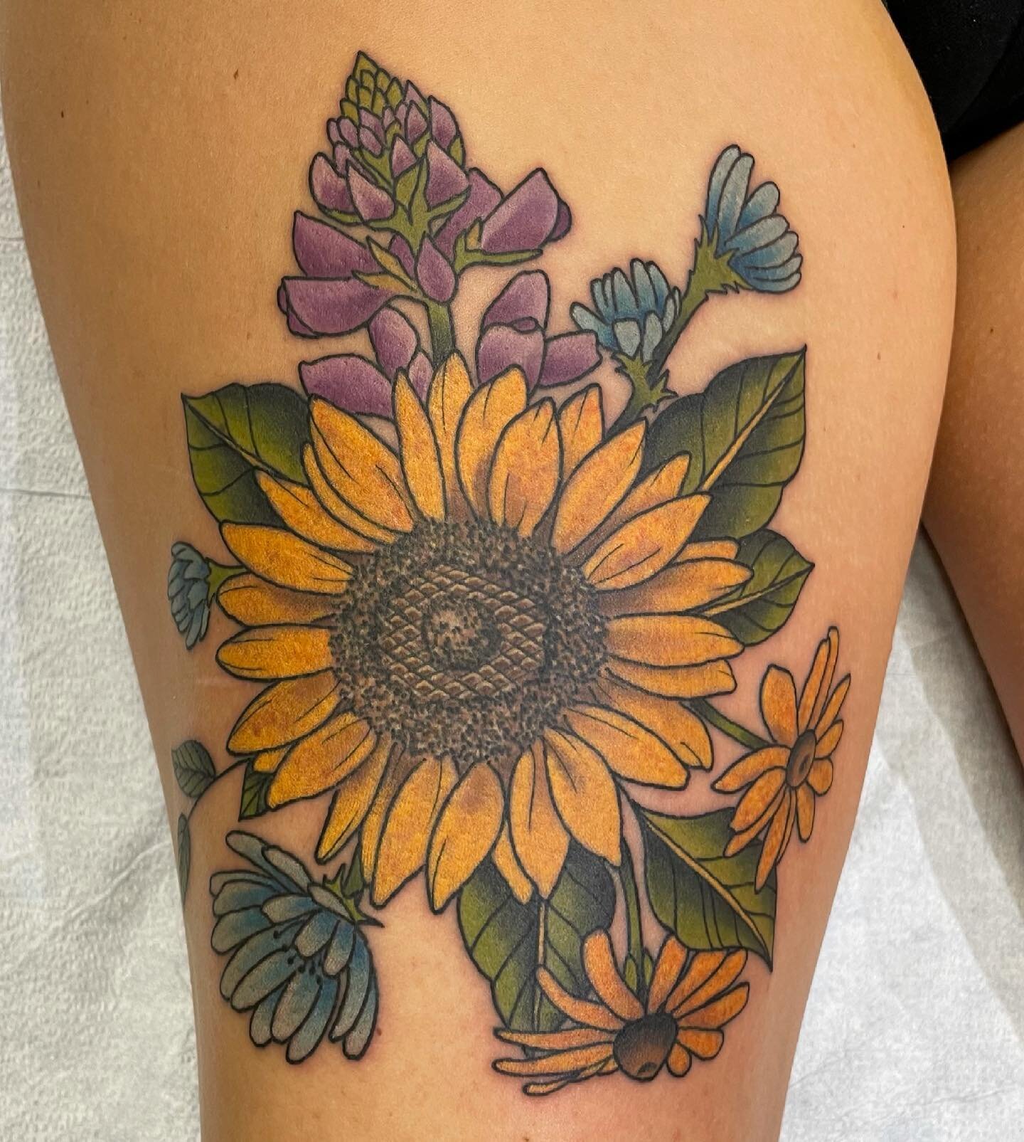 Flowers done by @ryanwhitsontattoo today at #spitfiretattoocville #cvilletattooartist #tattoo #flowers #flowertattoo #sunflower #sunflowertattoo #chickory #blackeyedsusan #lupine #color #thightattoo #beautiful