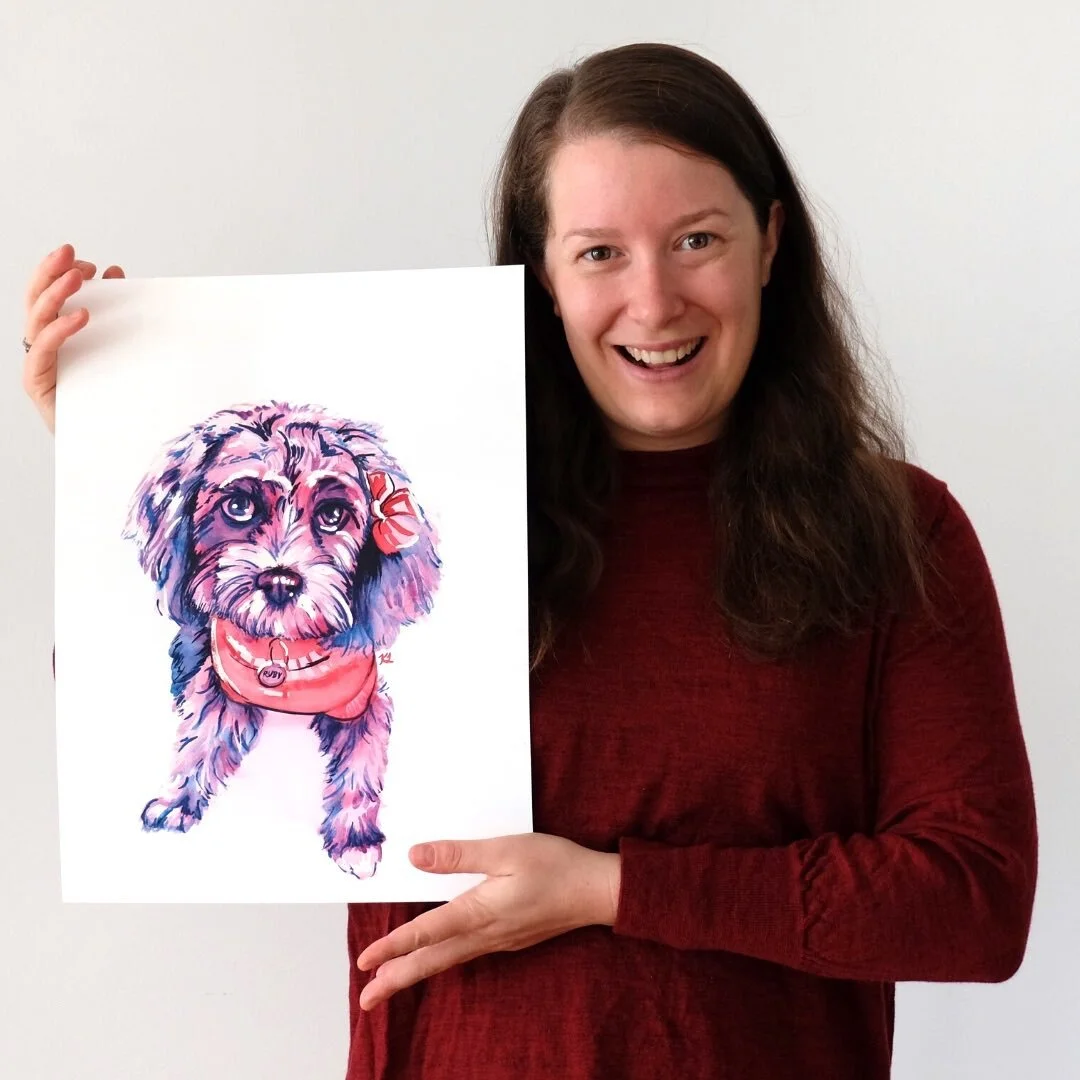Pink, red and purple watercolour portrait of a spoodle dog held by the artist