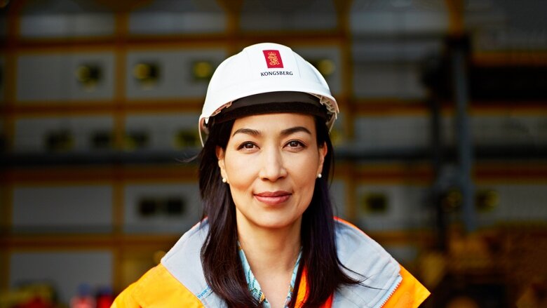 Woman wearing work clothes and construction helmet - Kongsberg
