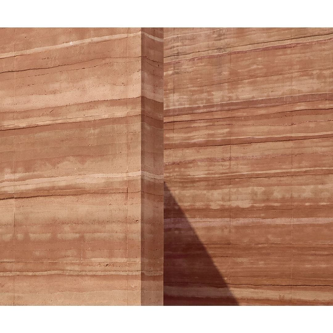 How can we turn to materials that answers the brief better? Can these materials provide more than a function?

Rammed earth evokes feelings of earthiness, warmth, and connection to nature. The rhythm, pattern, textures, and colors address the visual 