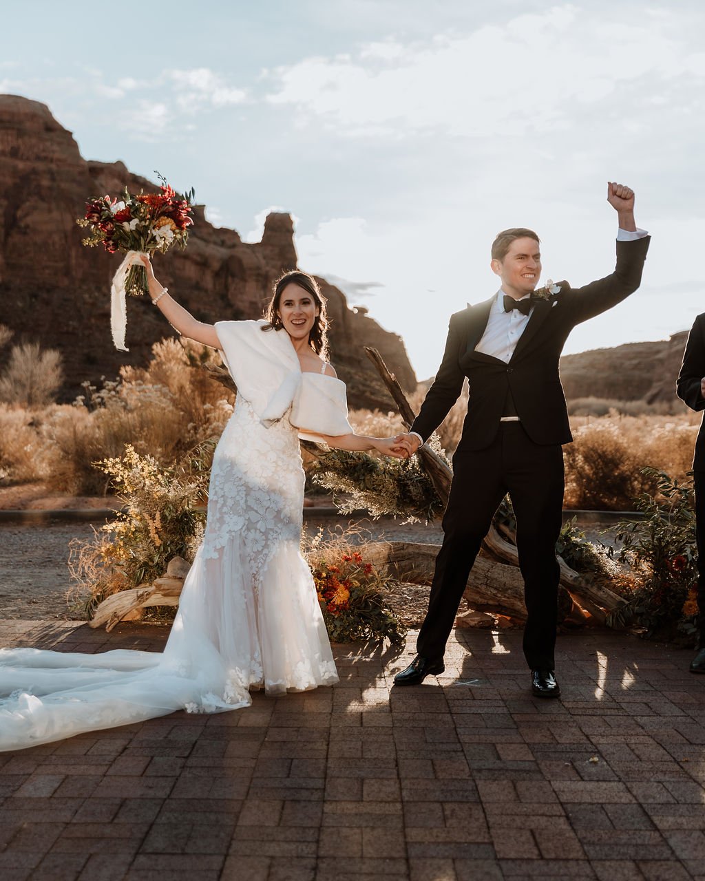 couple cheers at winter wedding ceremony